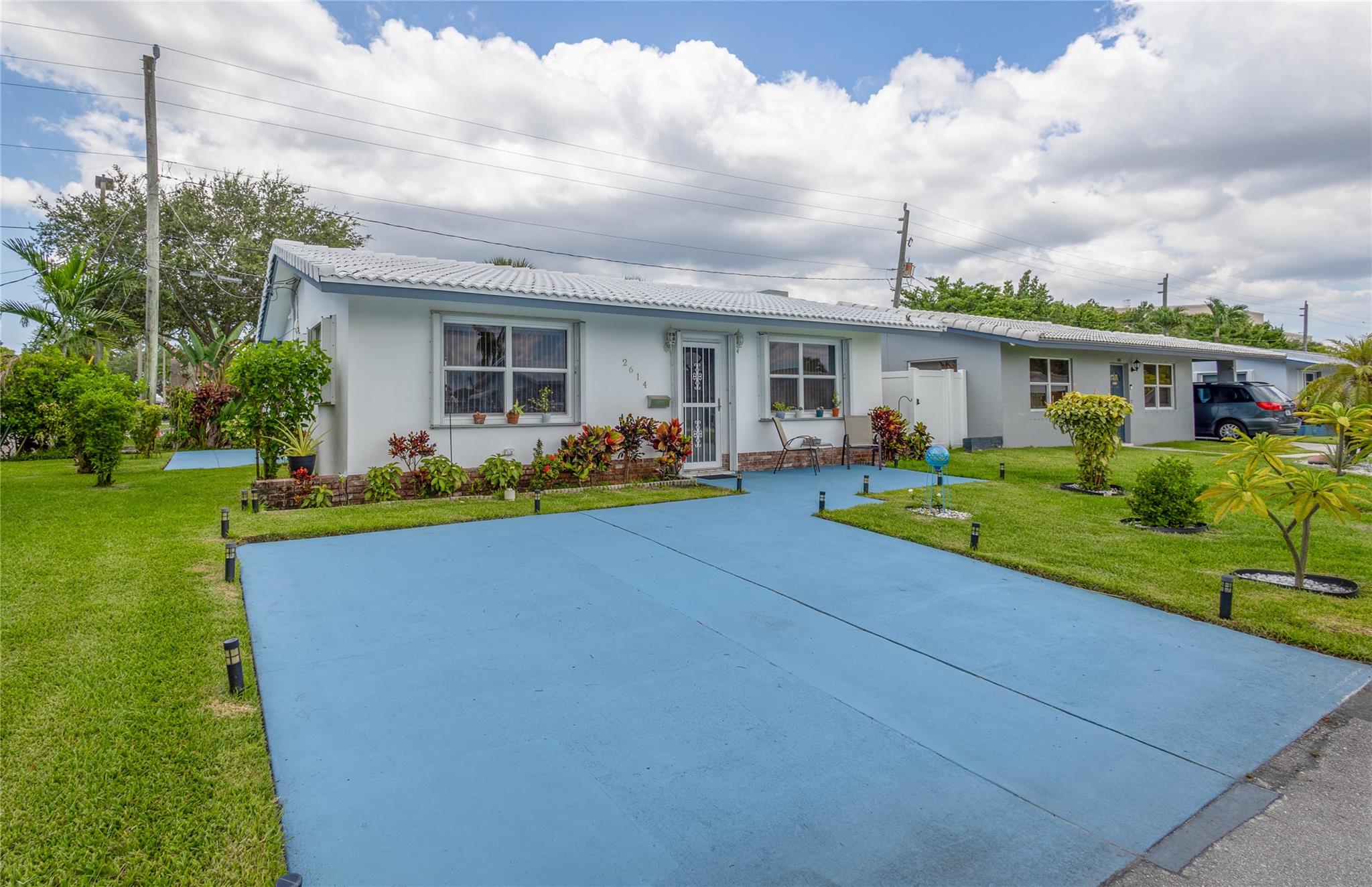 Front of the house with front beautiful yard and driveway.