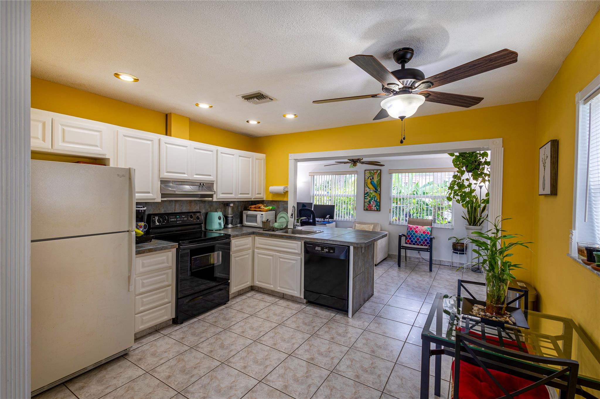 Living room with view to the eat-in kitchen and Florida room.