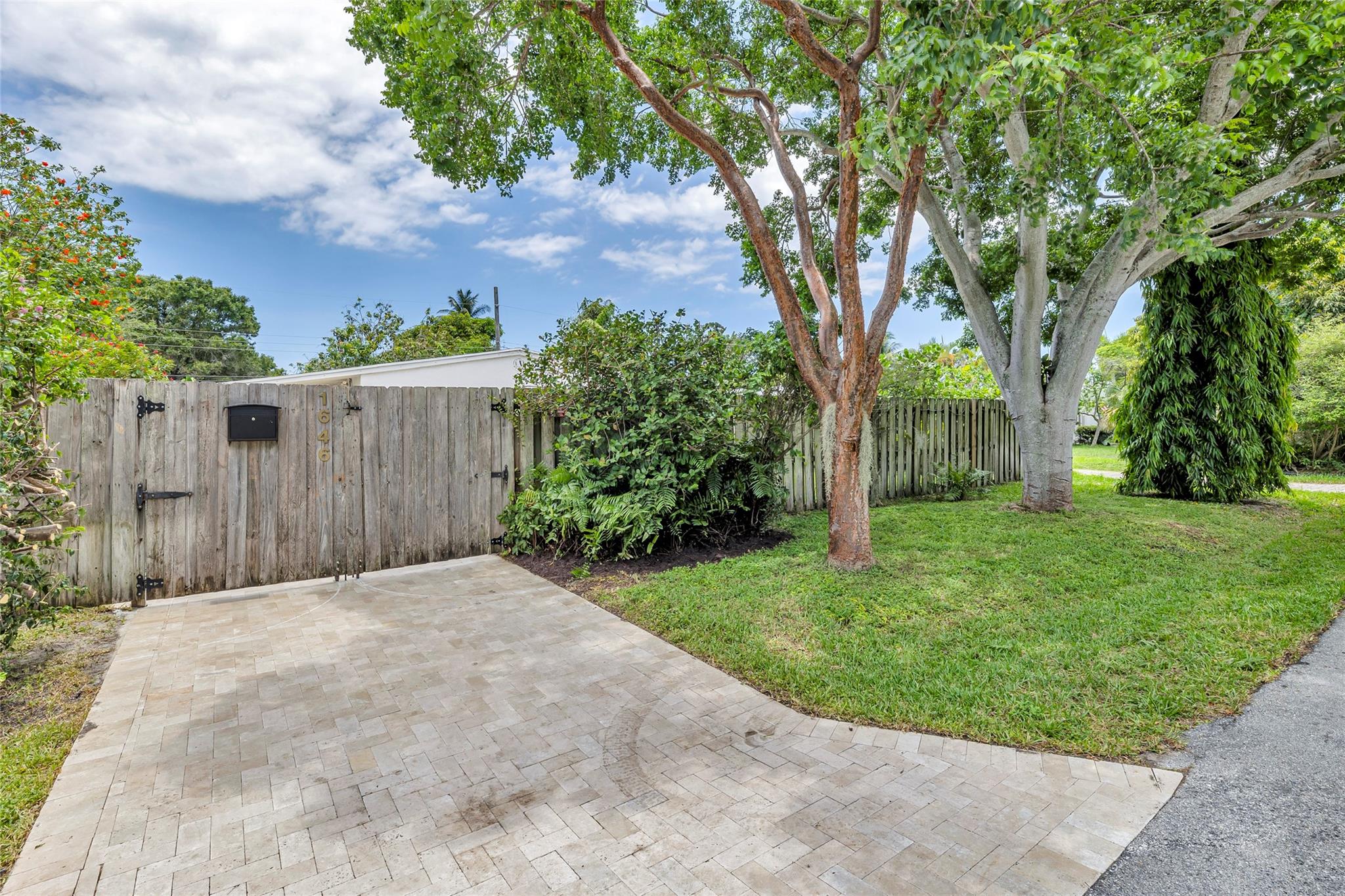 Private entrance and yard with gorgeous vegetation inside and outside of the fenced in yard