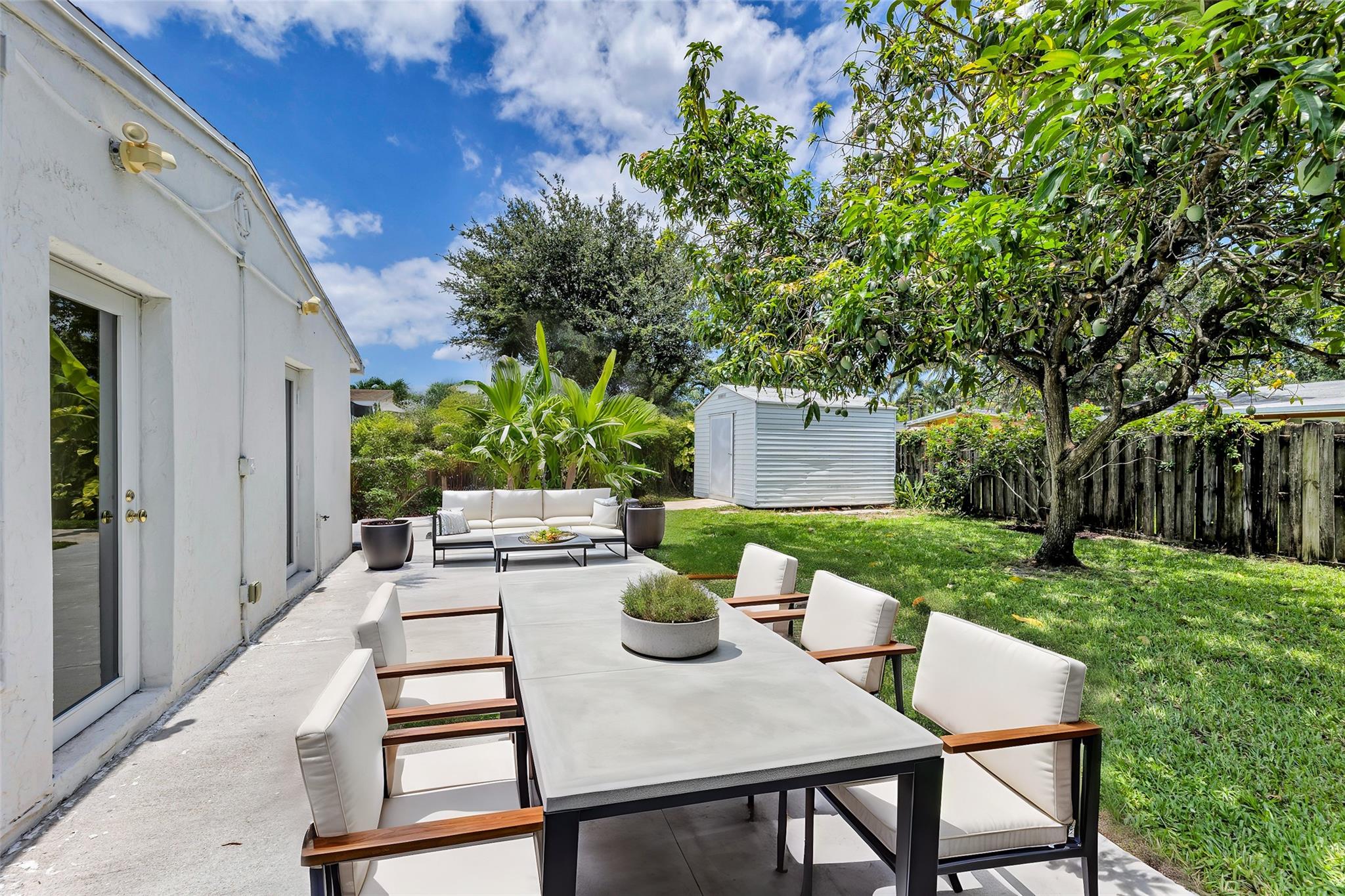Spacious Back patio - Virtually staged and with shade provided by delicious mango tree