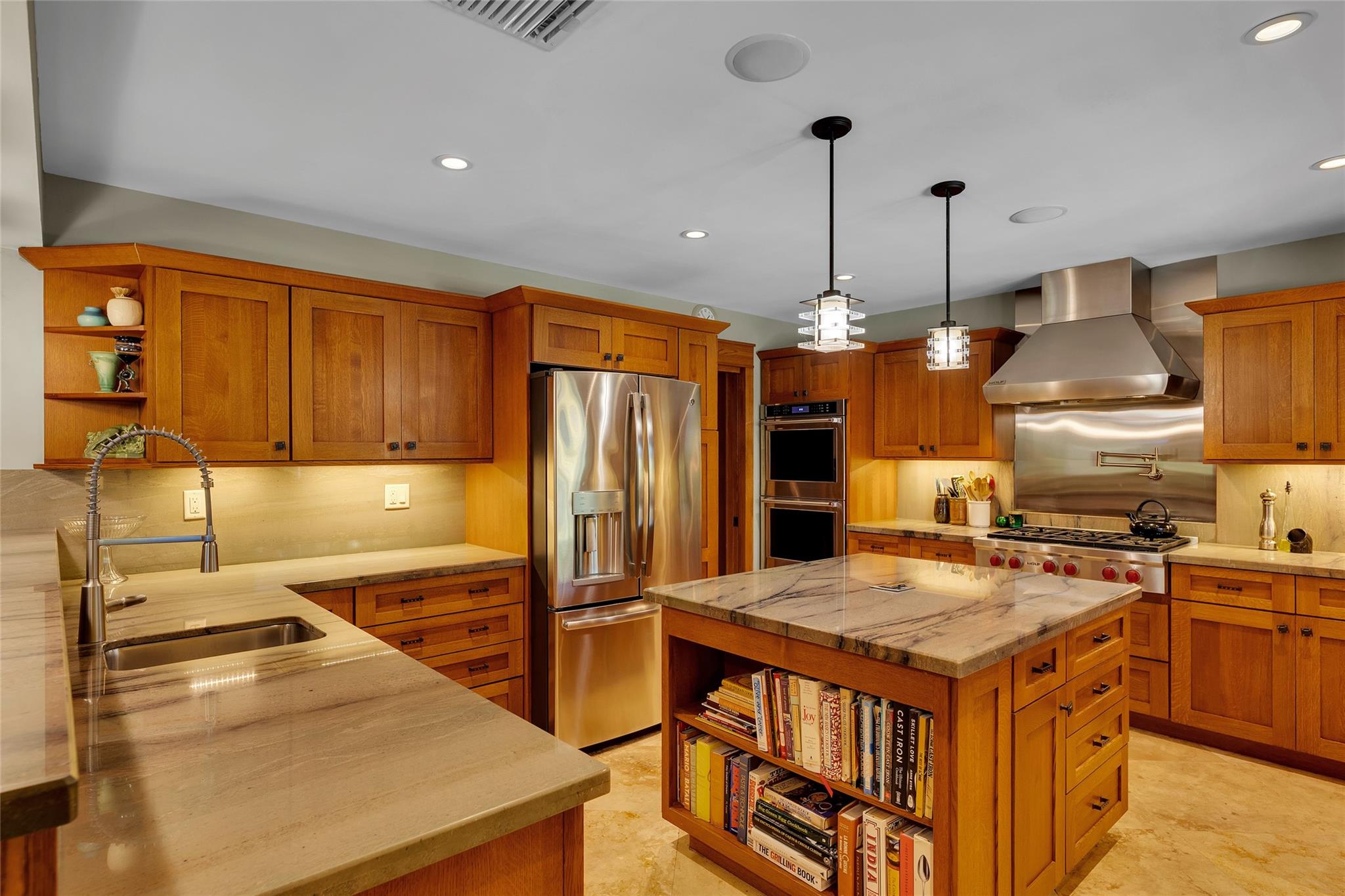 Spectacular Kitchen with plentiful custom wood cabinets, unique granite countertops and Island with ample storage.  Wolf stove (gas) and hood