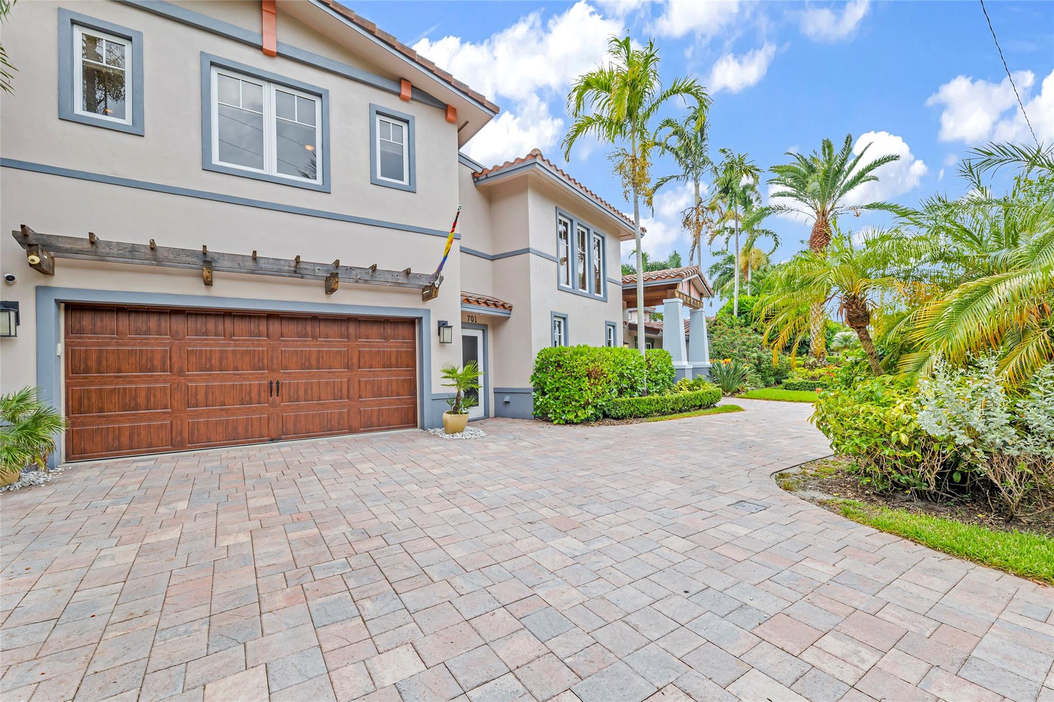With oversized 2.5 car garage with separate garage pedestrian entrance and large paver circular driveway