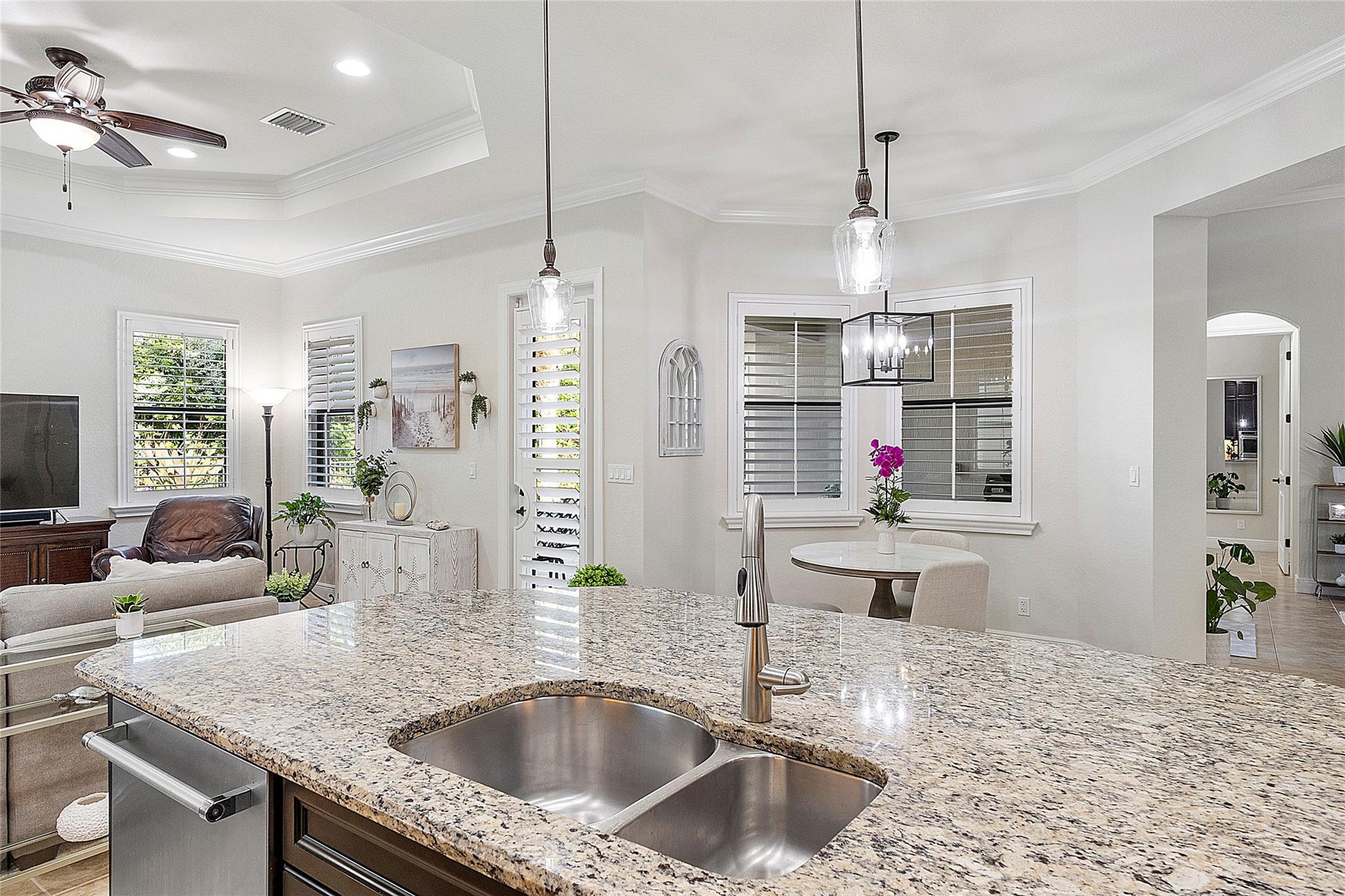 Kitchen center island with eat-in kitchen, Tray ceiling with crown moldings, Plantation shutters & patio door,