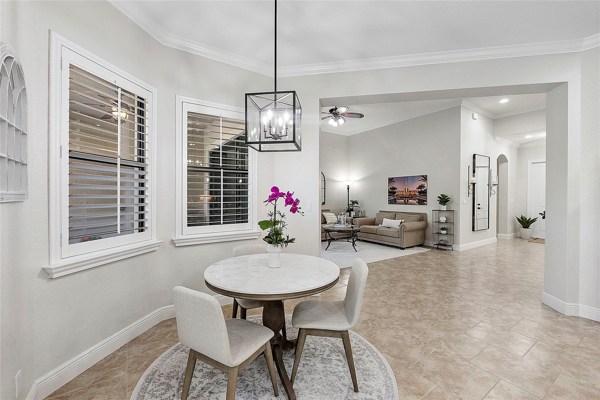 Eat-in dining area is additional to the formal dining room, Plantation shutters throughout the home, pendant designer chandelier matching to the kitchen lighting and cabinetry.