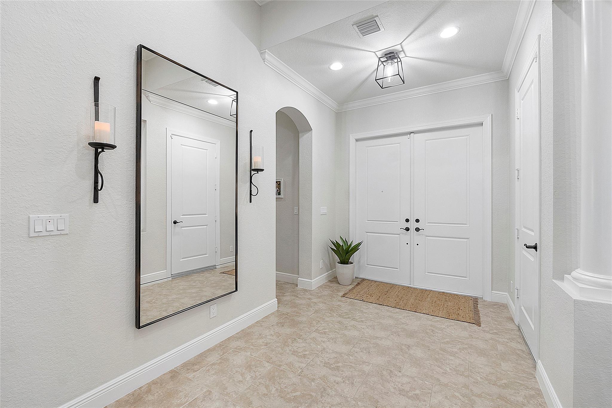 Double door entryway into open floorplan, 12 foot ceilings