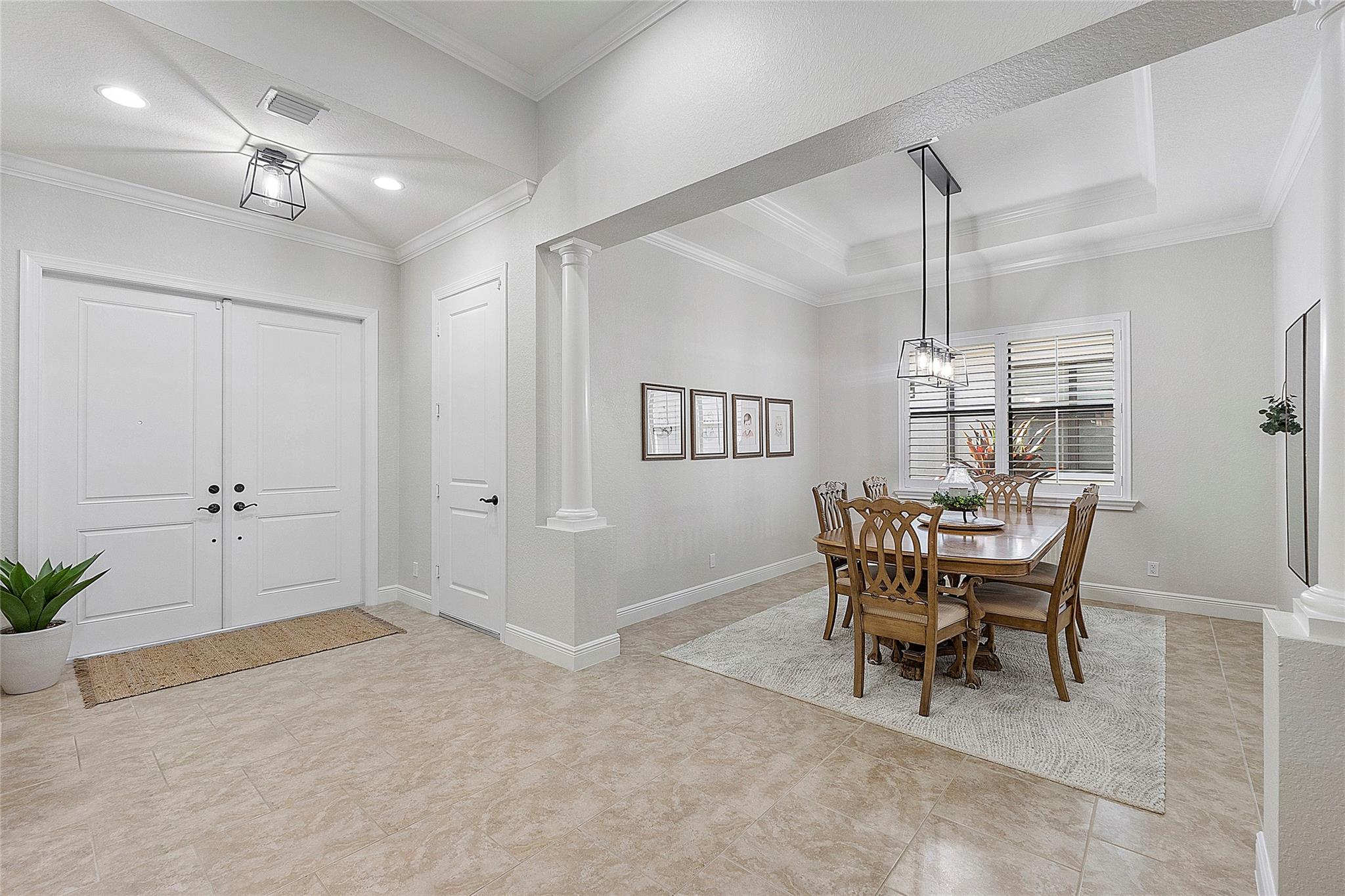 Formal dining room with tray ceiling & crown moldings,