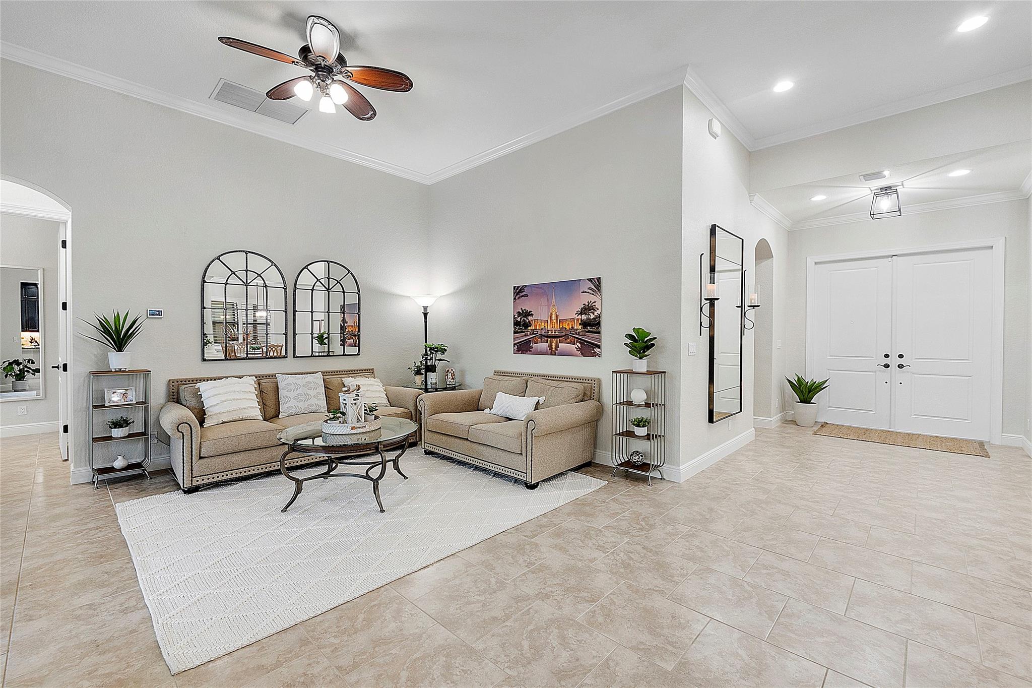 Double door entryway leading into the open floor plan living room