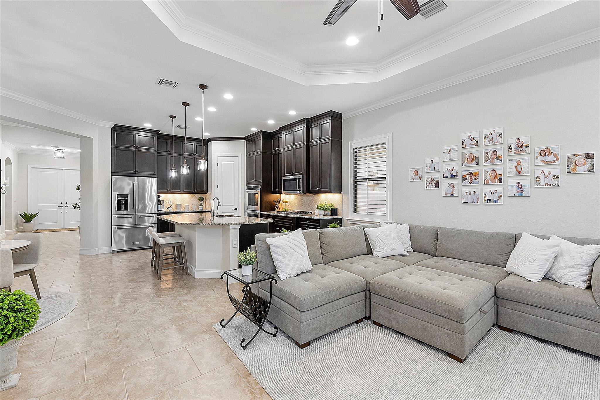 Family room & kitchen looking from back of house to front double door entry.