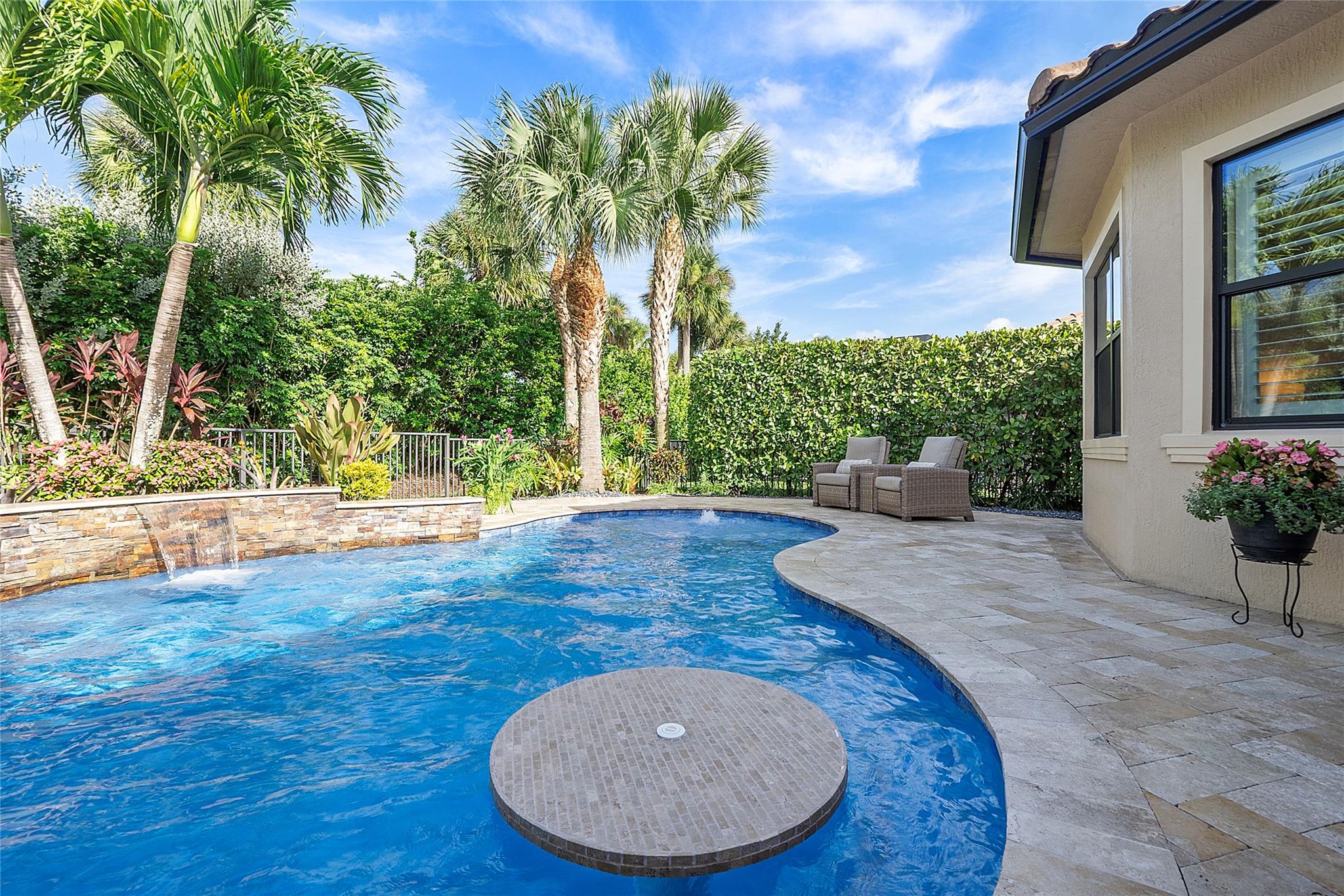 Tropical Oasis private pool with stone accent wall & waterfall,