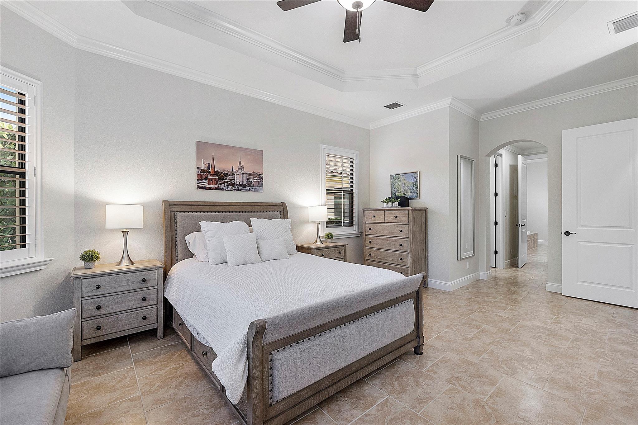 Master bedroom with tray ceilings and crown moldings, Italian tile leading to master bathroom en-suite