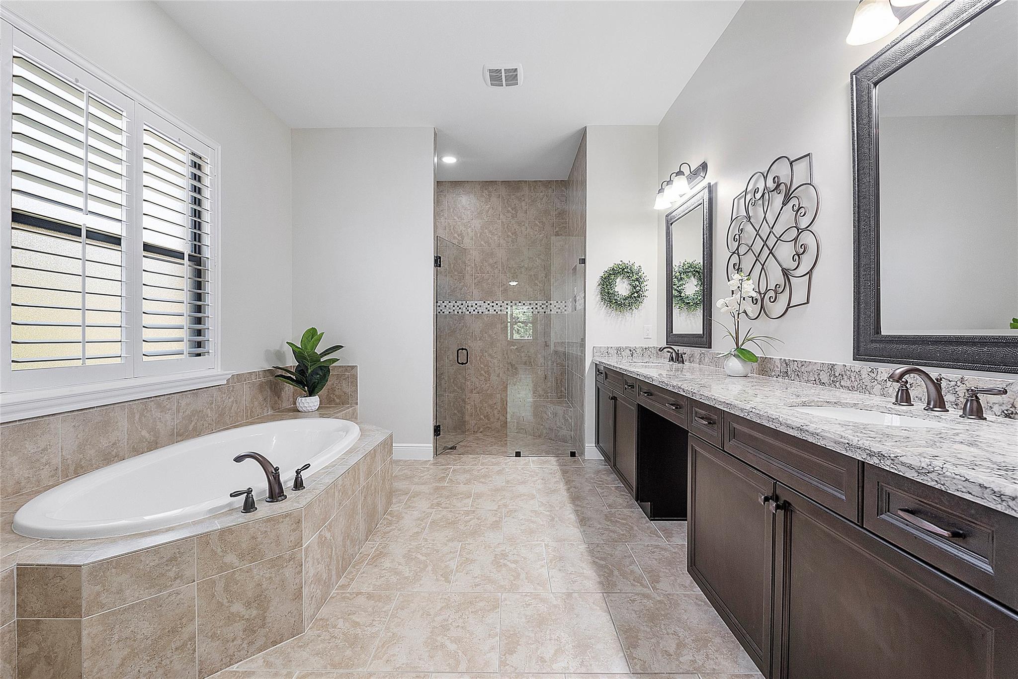 Cappuccino cabinets (real solid wood) with double vanities & marble countertops,
Deep soaking tub, floor to ceiling Italian tile.