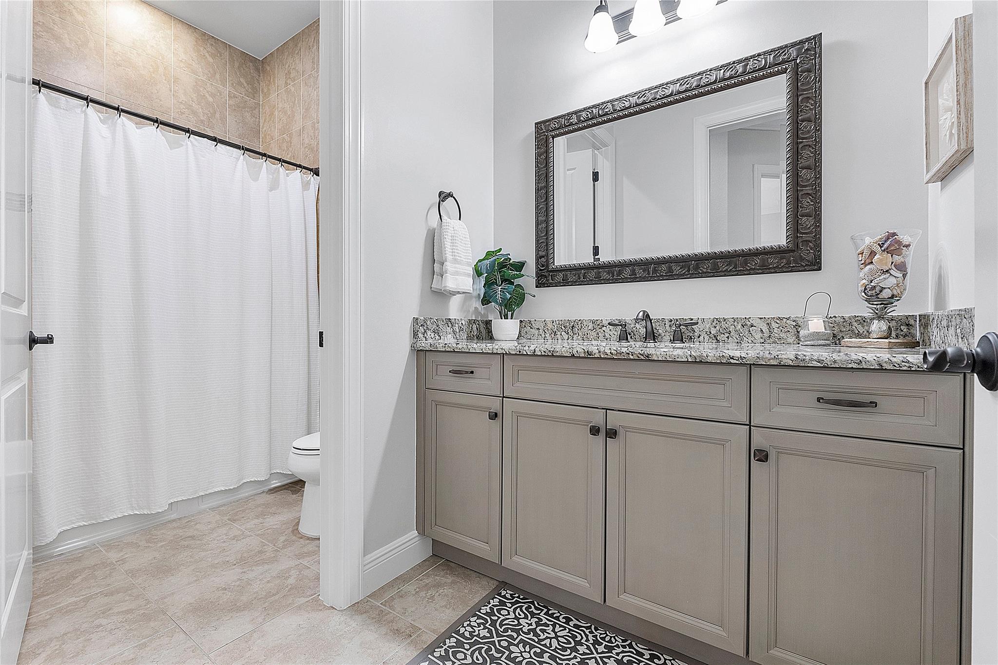 Downstairs spacious full guest bathroom with separate water closet.
