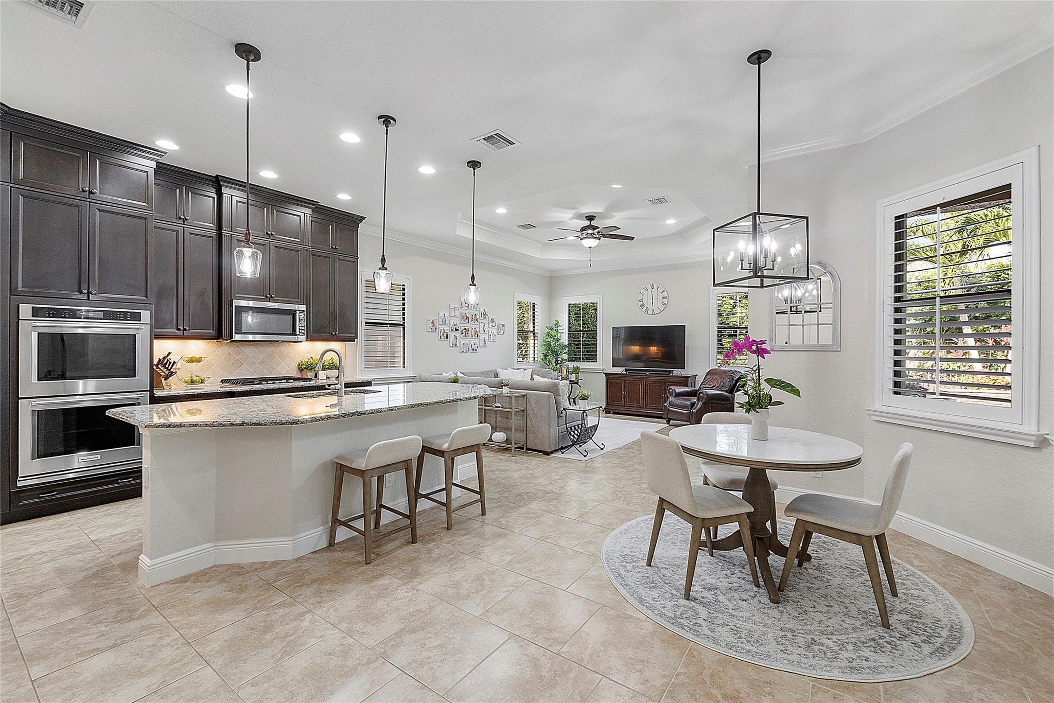 Open floorplan Kitchen, Dining & family rooms all overlooking the tranquil private pool oasis.