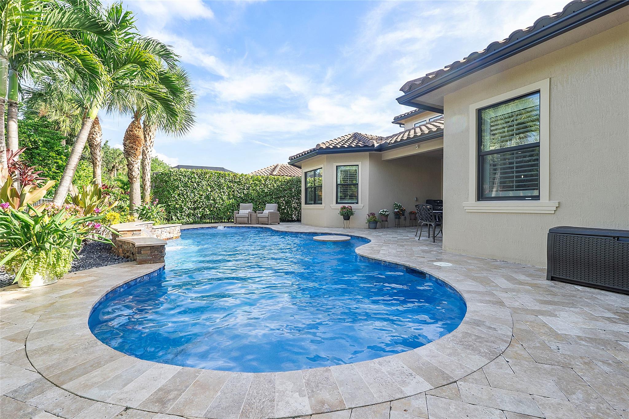 Immaculately maintained lush landscaping adorns this LED lighted changeable colored heated pool with multi color lighting that can remotely change every 20 seconds or keep it on lilac or orange to match the sunset!