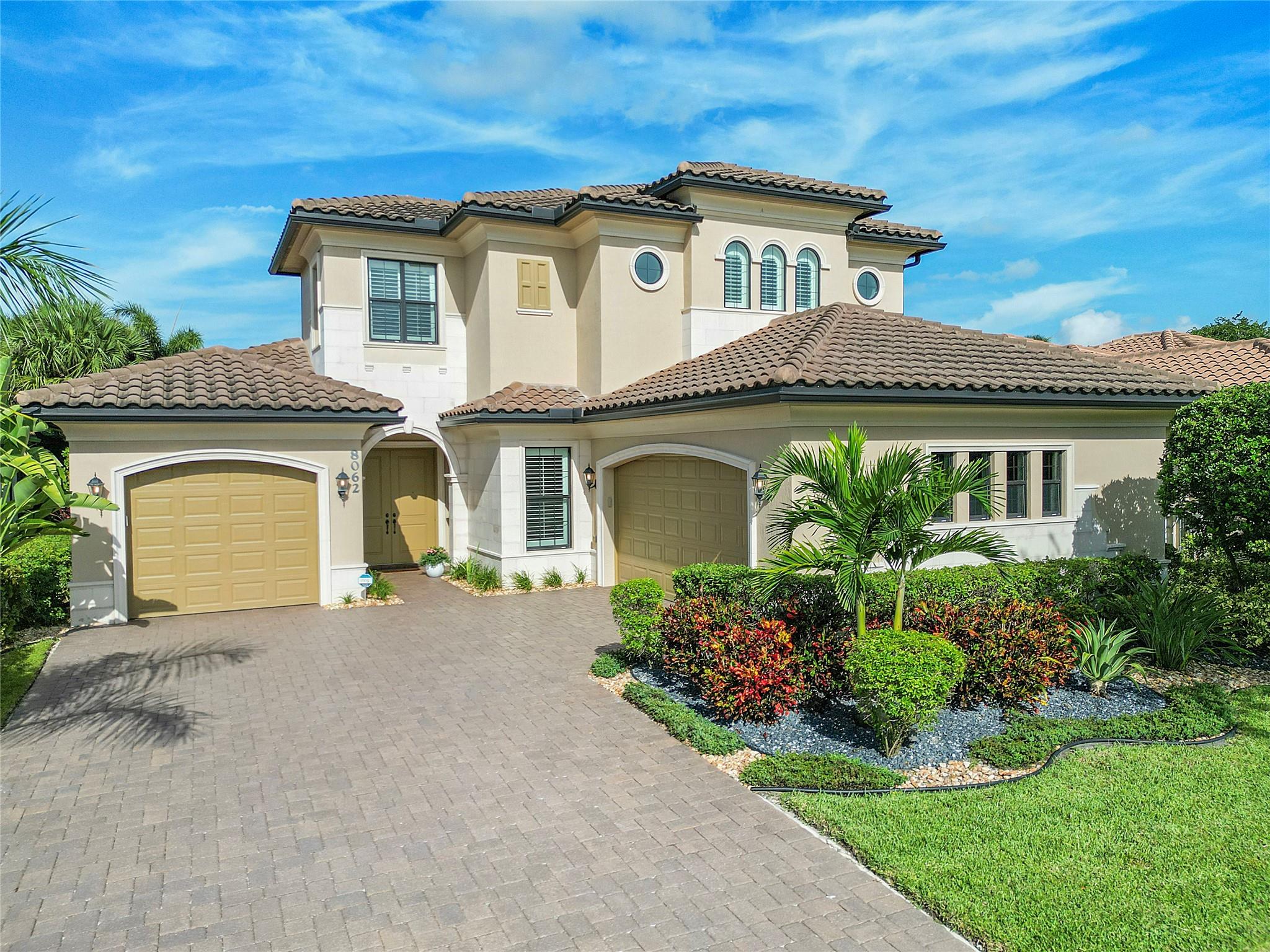 Daytime front of the property with lush landscaping