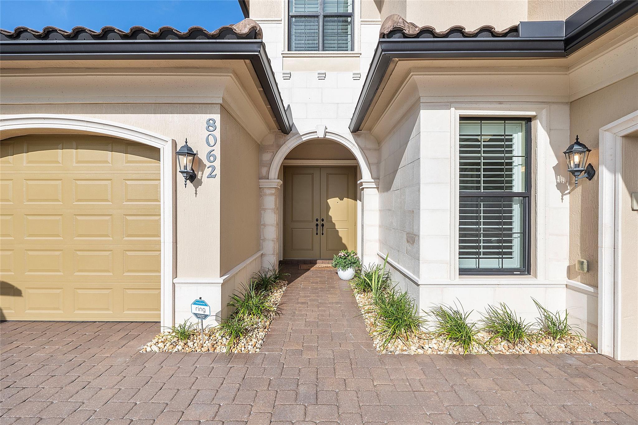 Courtyard entryway with stone columns & pavers