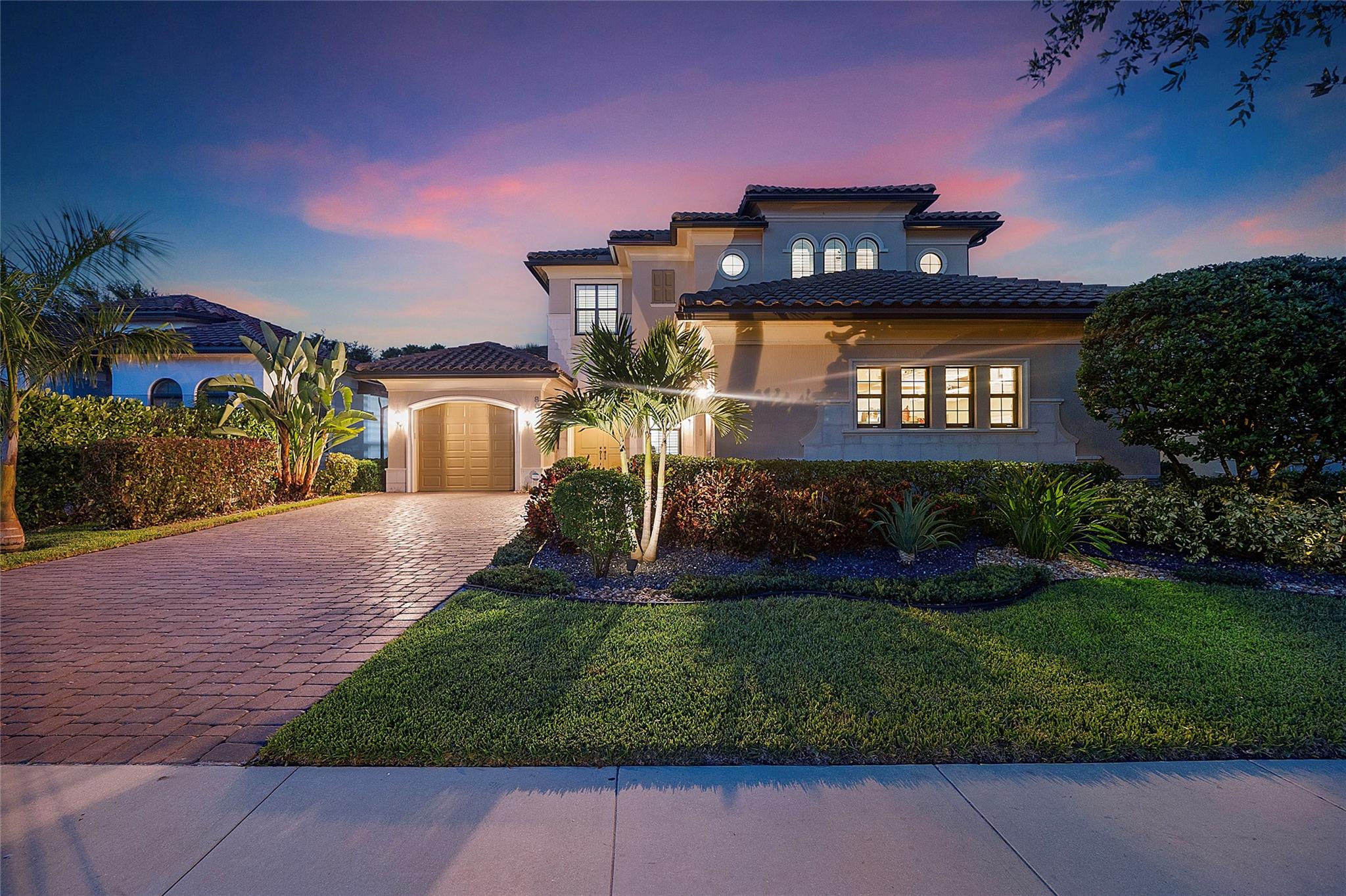A streetside sunset view of the front of the house.