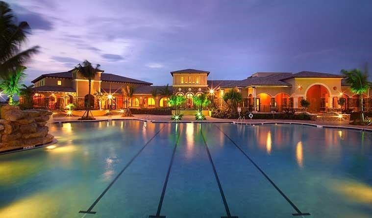 Heron Bay's famous resort style heated pool with rock waterfalls and spa, lap lanes and hotdog cafe for all the family