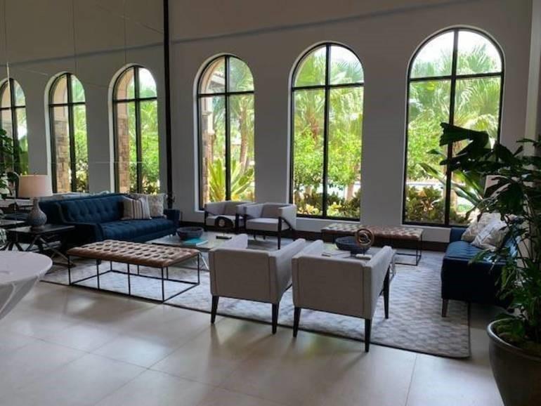 Part of our beautiful indoor clubhouse sitting area overlooking the pool through our magnificent arched windows.