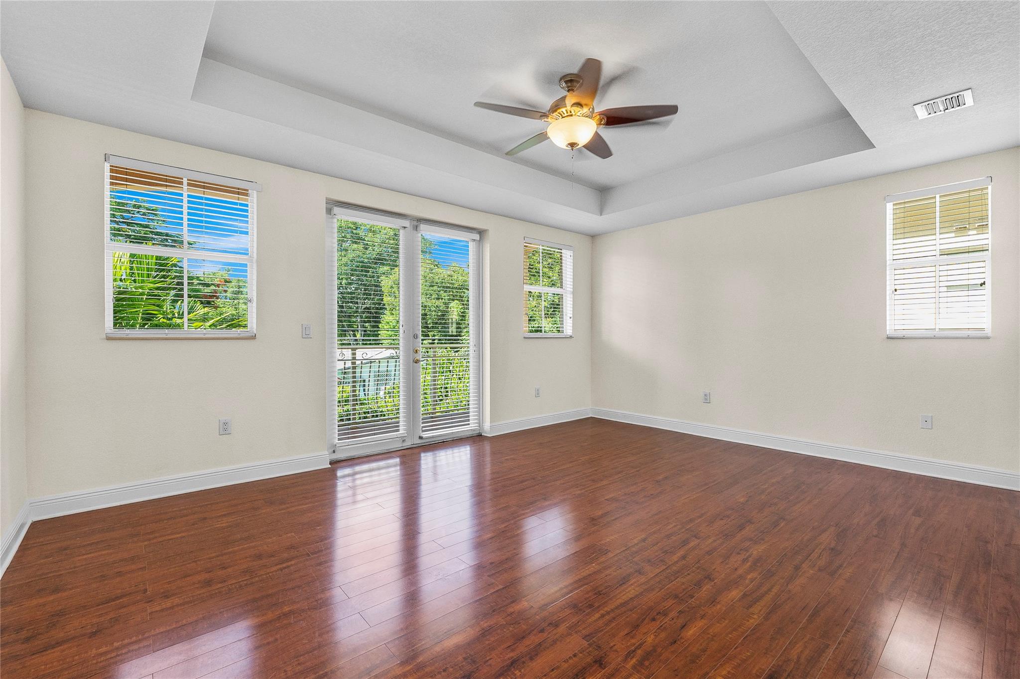 Primary suite w/balcony and pool view.