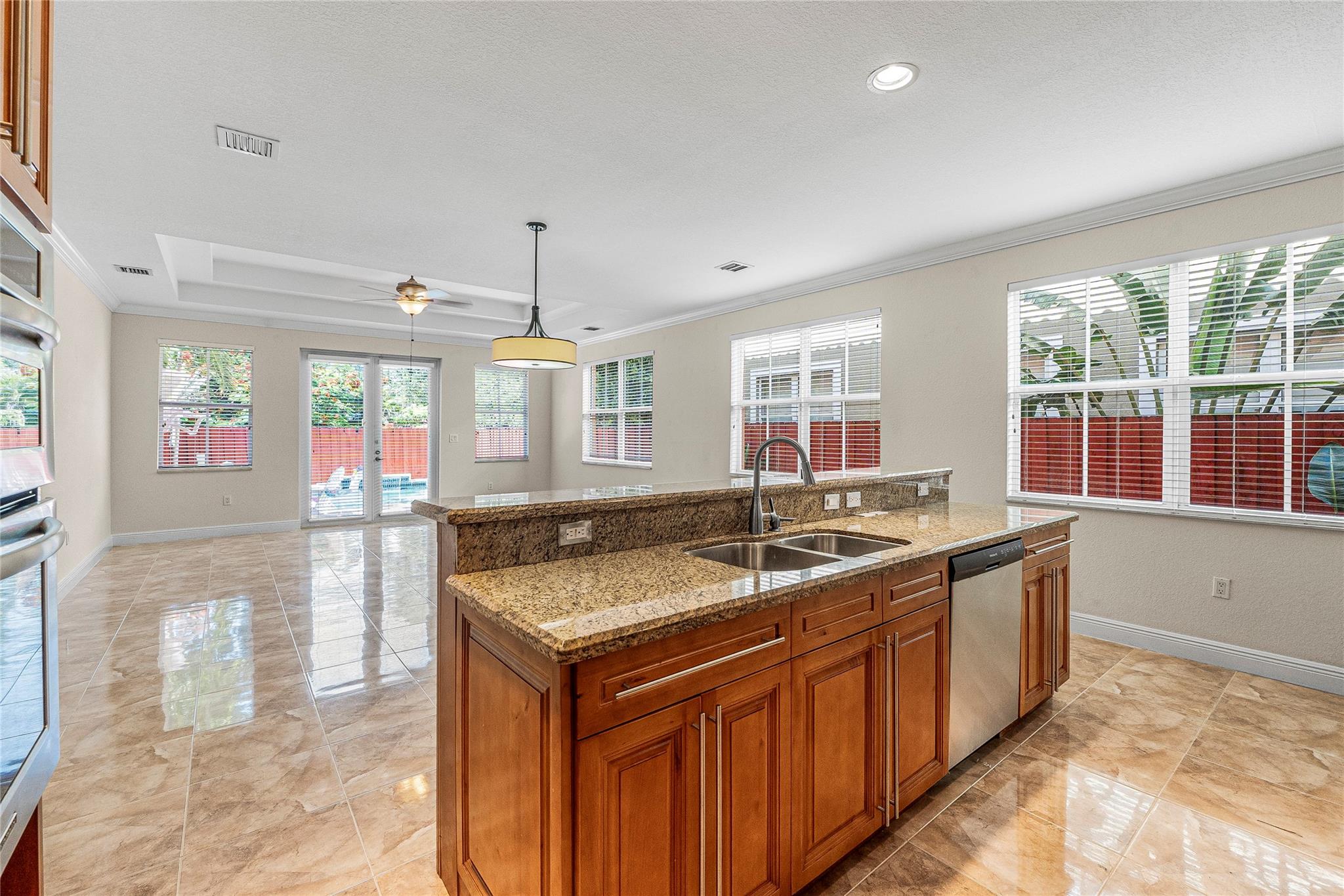 Large kitchen looking toward private pool and backyard.