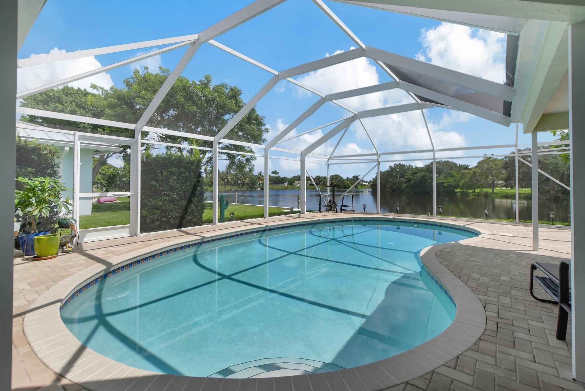 BREATHTAKING LAKEFRONT SCREENED-IN POOL HOME ON A QUIET STREET IN BOCA SQUARE! This stunning 3 bedroom (revertible to 4), 2 full bathroom home, offers 1,861 sq ft of living space.
