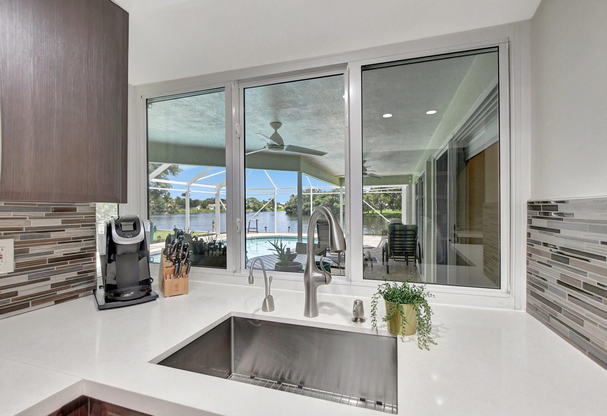 Kitchen with pool and lake views, windows open for pass thru for food and drinks.
