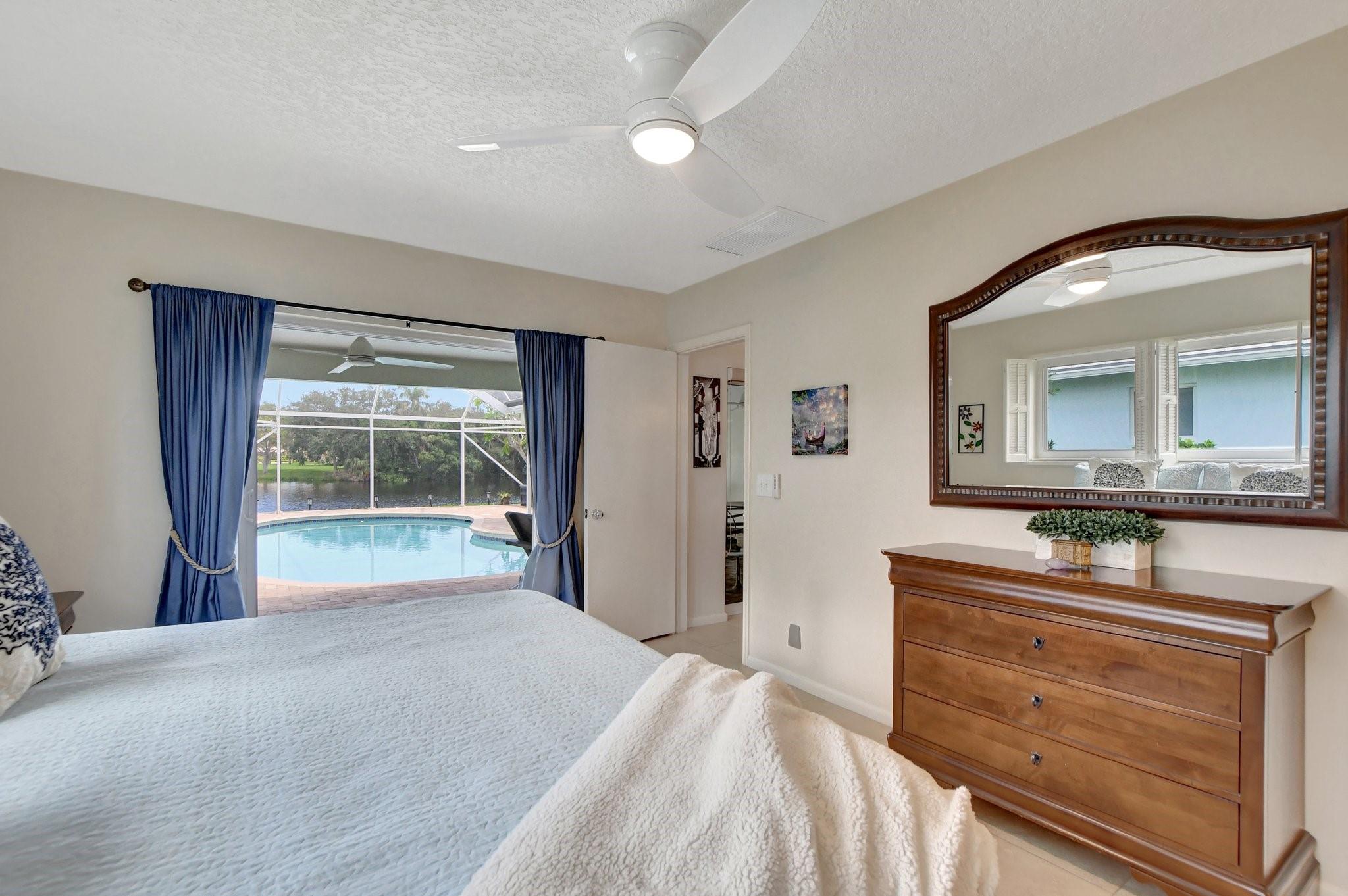 Primary bedroom view overlooking the pool and lake