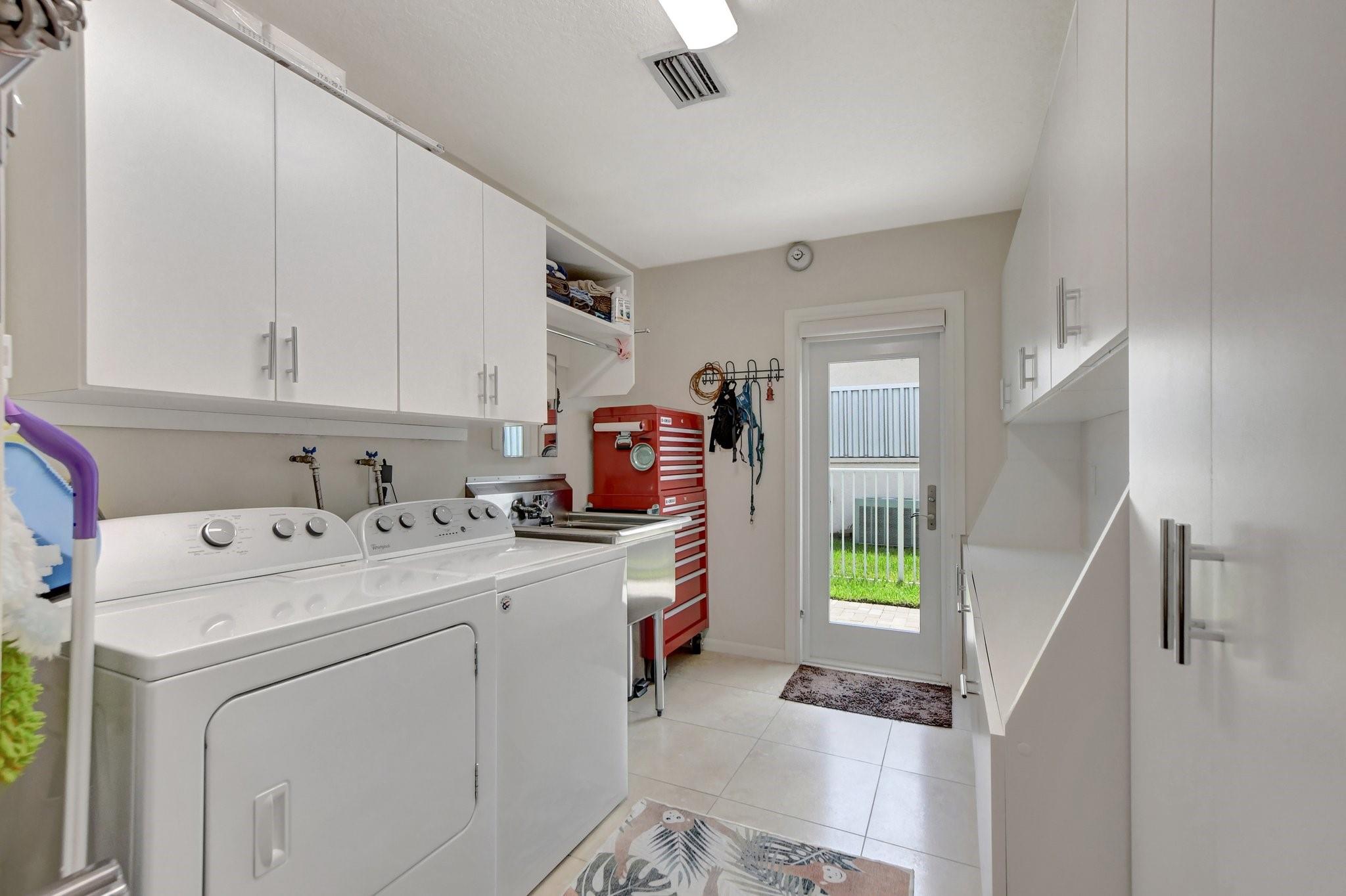 Extra-large laundry room with a commercial-sized stainless steel deep sink.