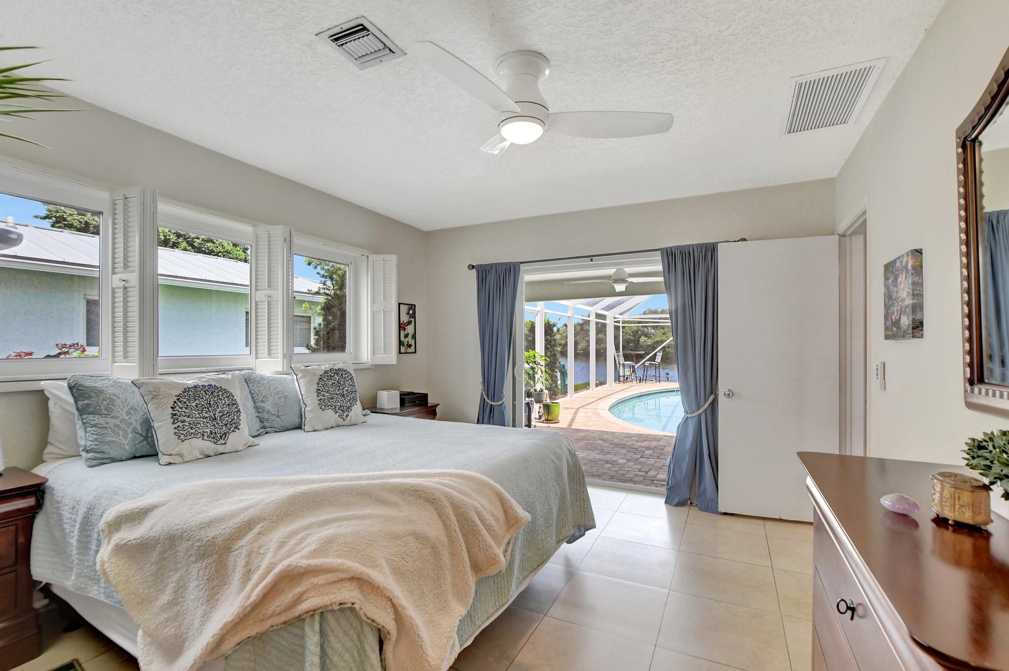 Primary bedroom view overlooking the pool and lake