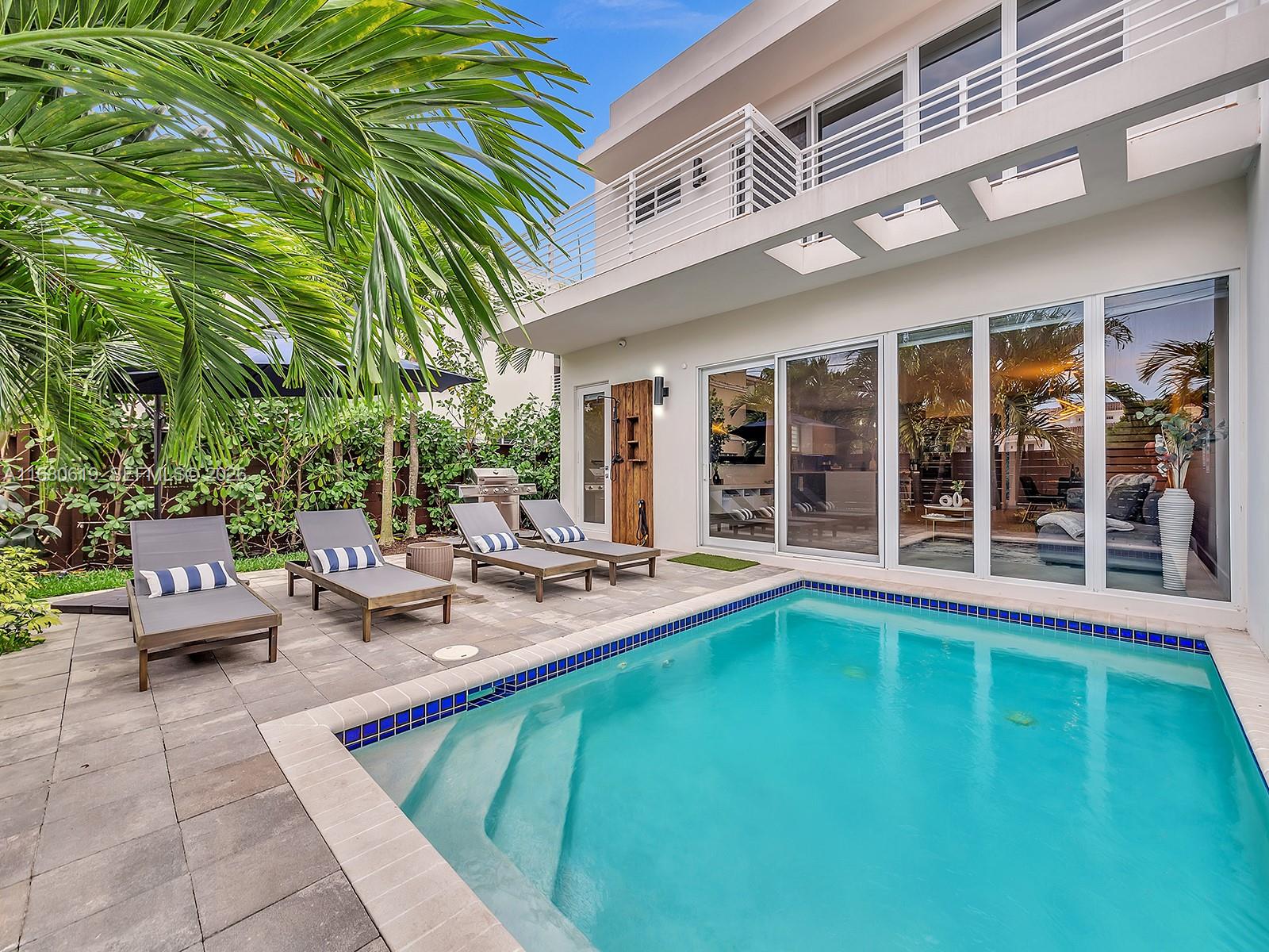 Contemporary 2018-built townhouse in the desirable Coral Ridge neighborhood. This spacious 4-bed, 4.5-bath home boasts an open layout with 9'8” ceilings, Bosch appliances with induction cooktop, quartz countertops, and European cabinetry. Floor-to-ceiling glass doors seamlessly blend indoor and outdoor living, leading to a heated pool. One en-suite bedroom is conveniently located downstairs, while upstairs features 3 en-suite bedrooms—two with private balconies—and a versatile den. The primary suite includes dual walk-in closets, dual sinks, a soaking tub, and motorized shades. Additional features include a two-car garage with electric car charger, Nest system, security cameras, no HOA, and an unbeatable location near the beach and shopping. A prime investment opportunity!
