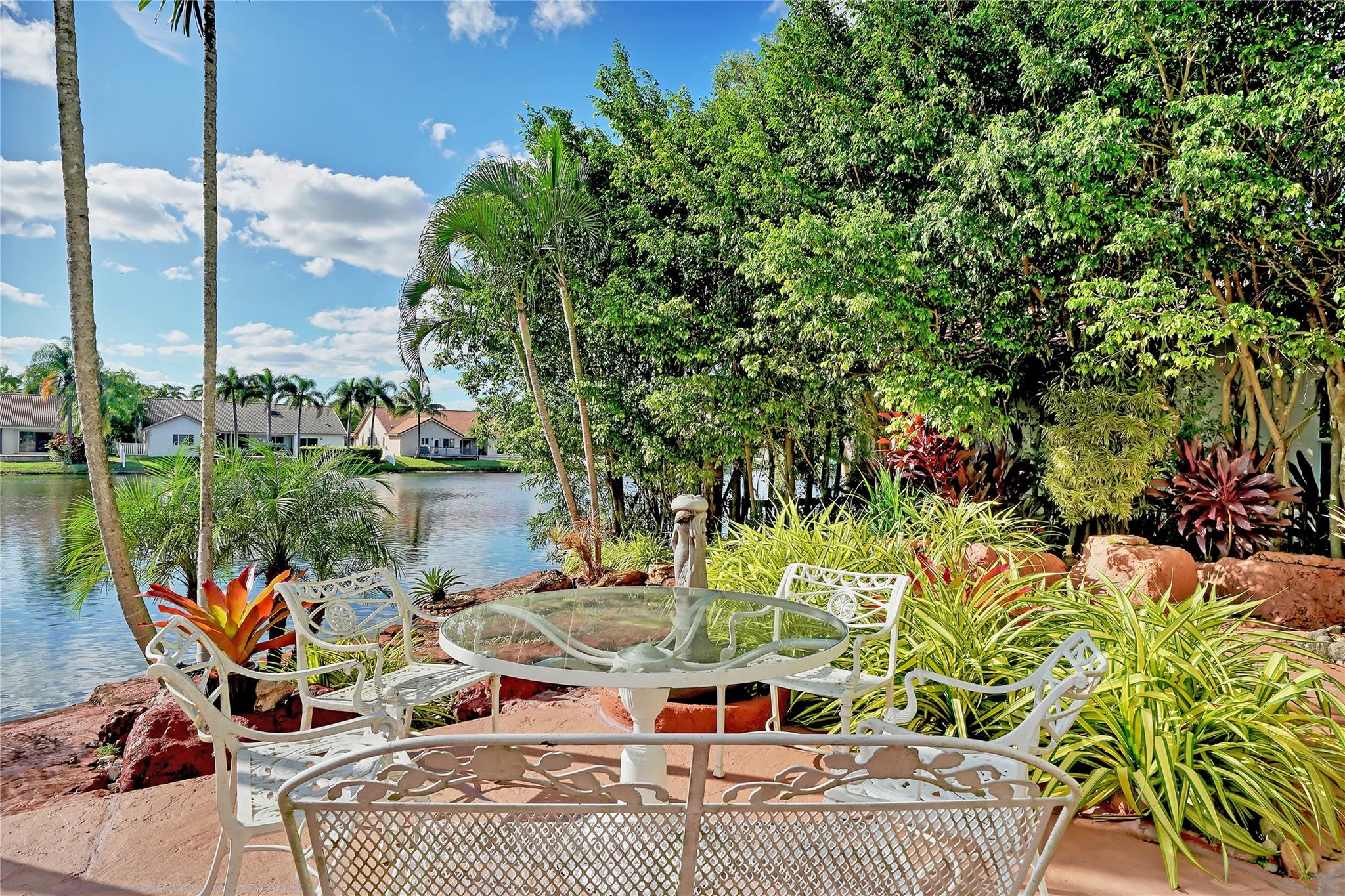 Backyard with exotic landscape,cusom made rocks and water fall opens to beautiful lake front
