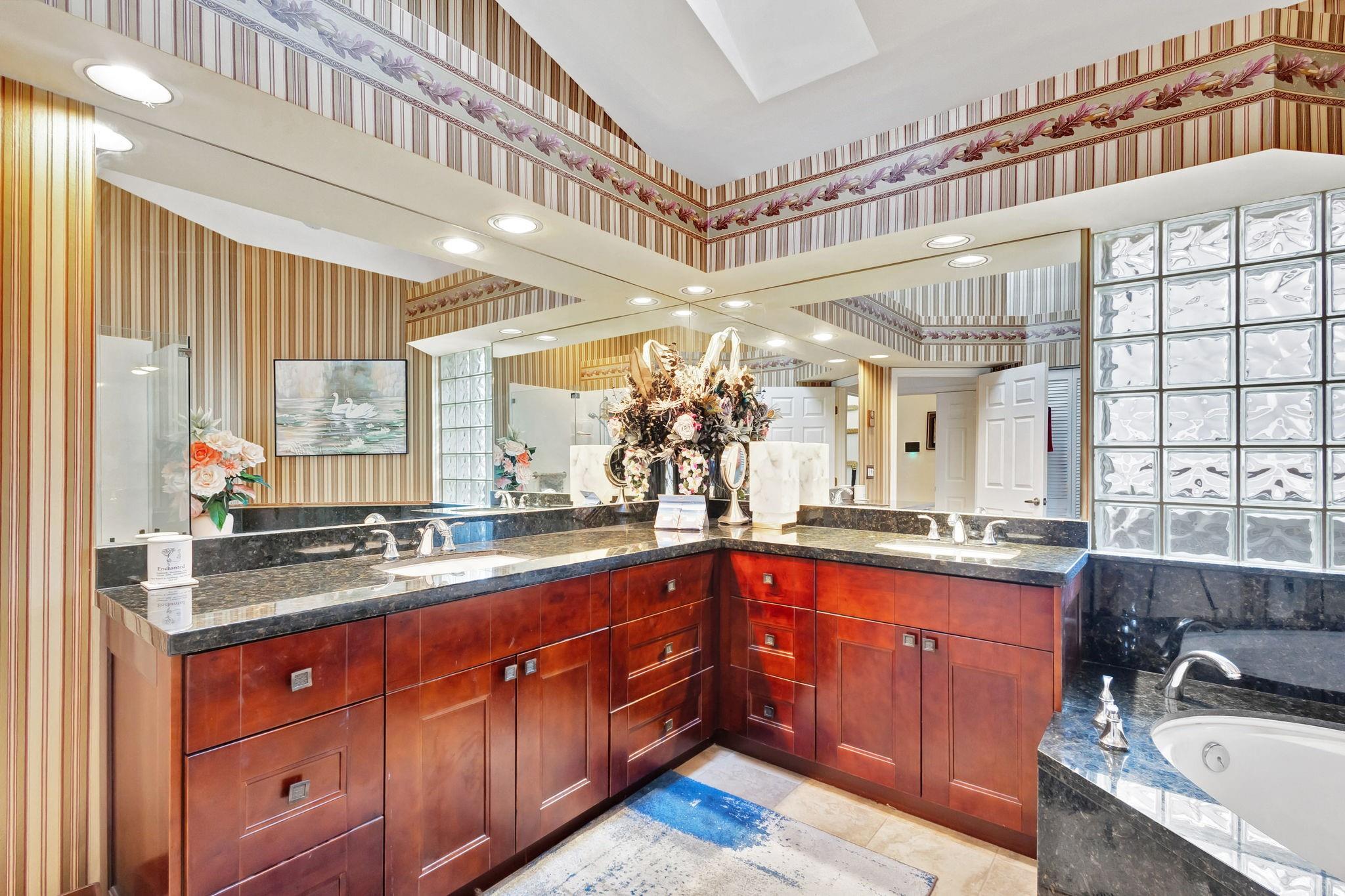 GRANITE AND WOOD IN PRIMARY BATHROOM