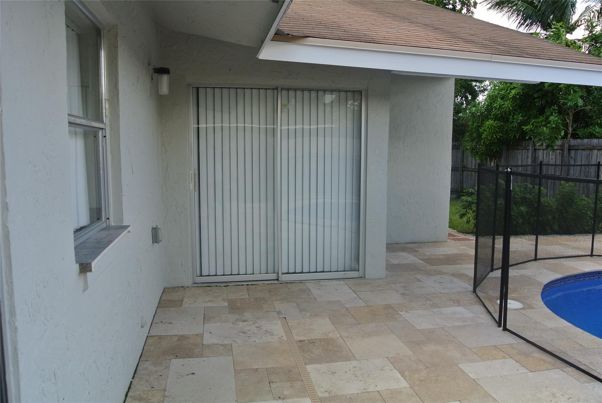 Beautiful Travertine Flooring in patio and around pool.