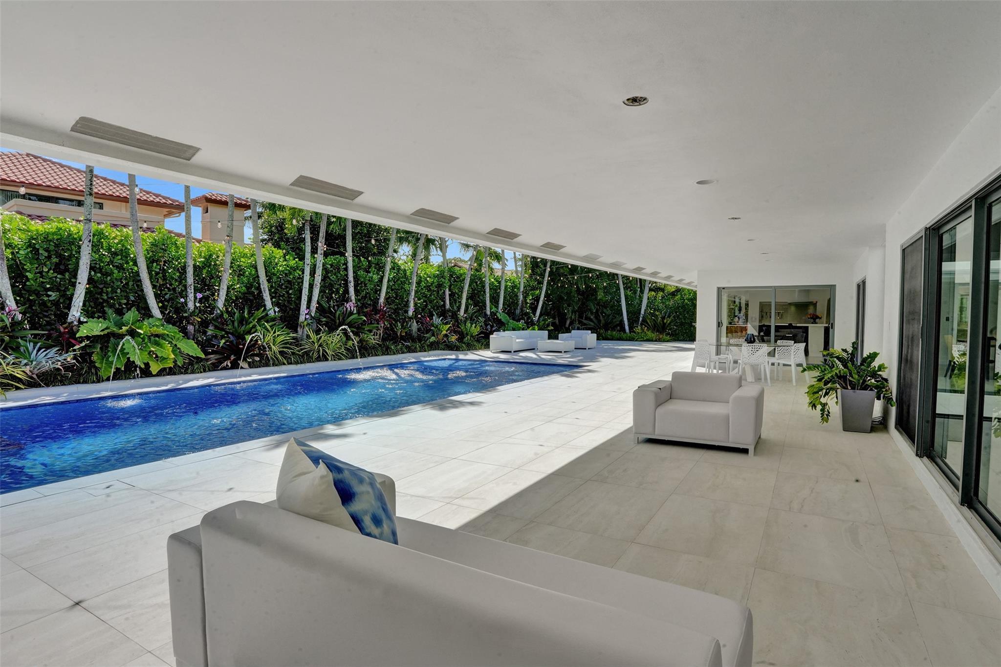 Oversized Covered Patio Terrace Overlooks Salt Water Heated Pool + Spa Lounge + Features Enough Space For Multiple Seating + Dining Areas...