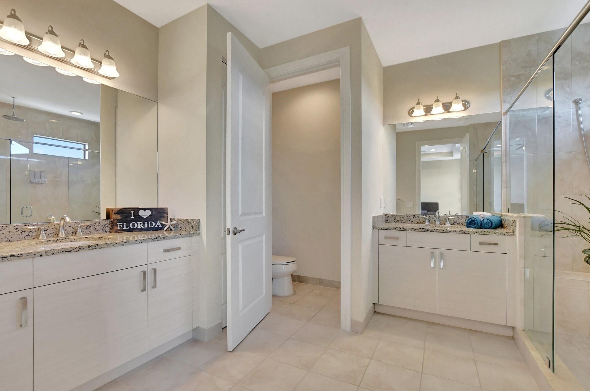 Gorgeous primary bath to enjoy the split vanities with granite counters and under mount sinks.