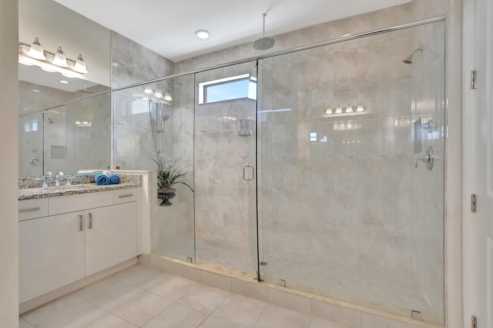 Extra large frameless shower with tile to the ceiling wil wash away your worries.