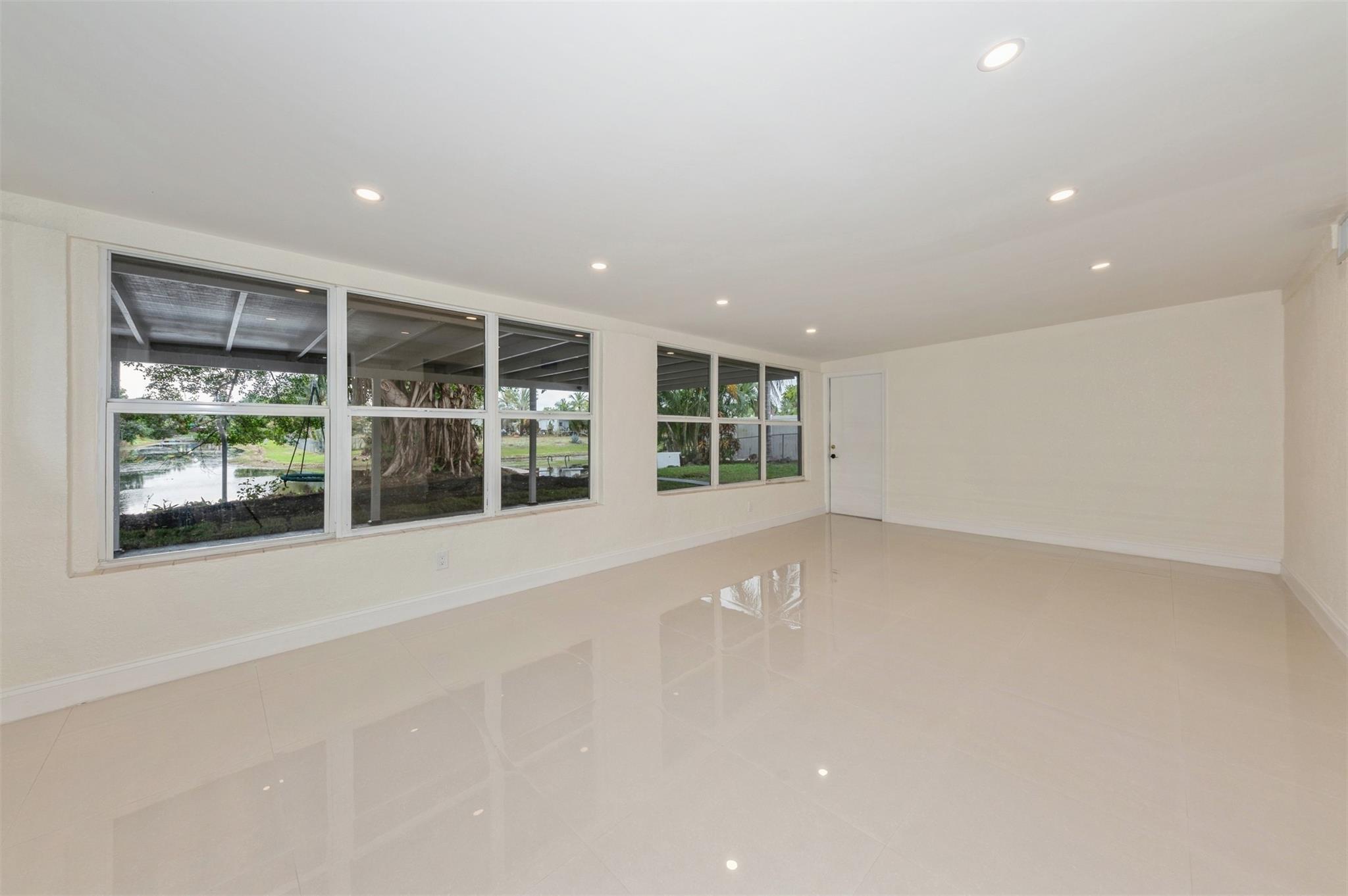 Florida Room with exit to the cover patio, backyard.