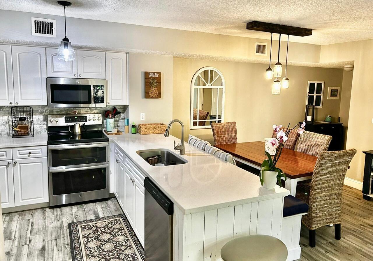 SELLER MOTIVATED! Discover this fully remodeled 2-bedroom, 2-bath condo in the sought after resort-style community of Lighthouse Cove, located in the prestigious Village of Tequesta. This beach-cottage-inspired home features a split floor plan and new porcelain wood-look tile flooring and quartz countertops in the kitchen and primary bathroom. Enjoy stainless steel appliances, custom bench seating with storage in the dining area and a completely updated 2nd bathroom. Both bedrooms offer ensuite baths and custom walk-in closets, while the primary suite boasts elegant shaker molding and shelving. Additional upgrades include accordion hurricane shutters, a new roof (2022), new lighting fixtures, and recent mechanical updatesa"hot water heater (2017) and AC (2019). heated pool &amp; spa area with a tranquil waterfall.  Entertain using the outdoor covered tiki hut with bar area, tables &amp; chairs, BBQ grills, tennis/pickleball courts &amp; a sand volleyball pit.  The clubhouse contains a fitness center, billiards room, an indoor racquetball court, library, business center &amp; the on site manager.  This home is move in ready &amp; convenient to Publix, shopping and a multitude of retail establishments &amp; restaurants!!