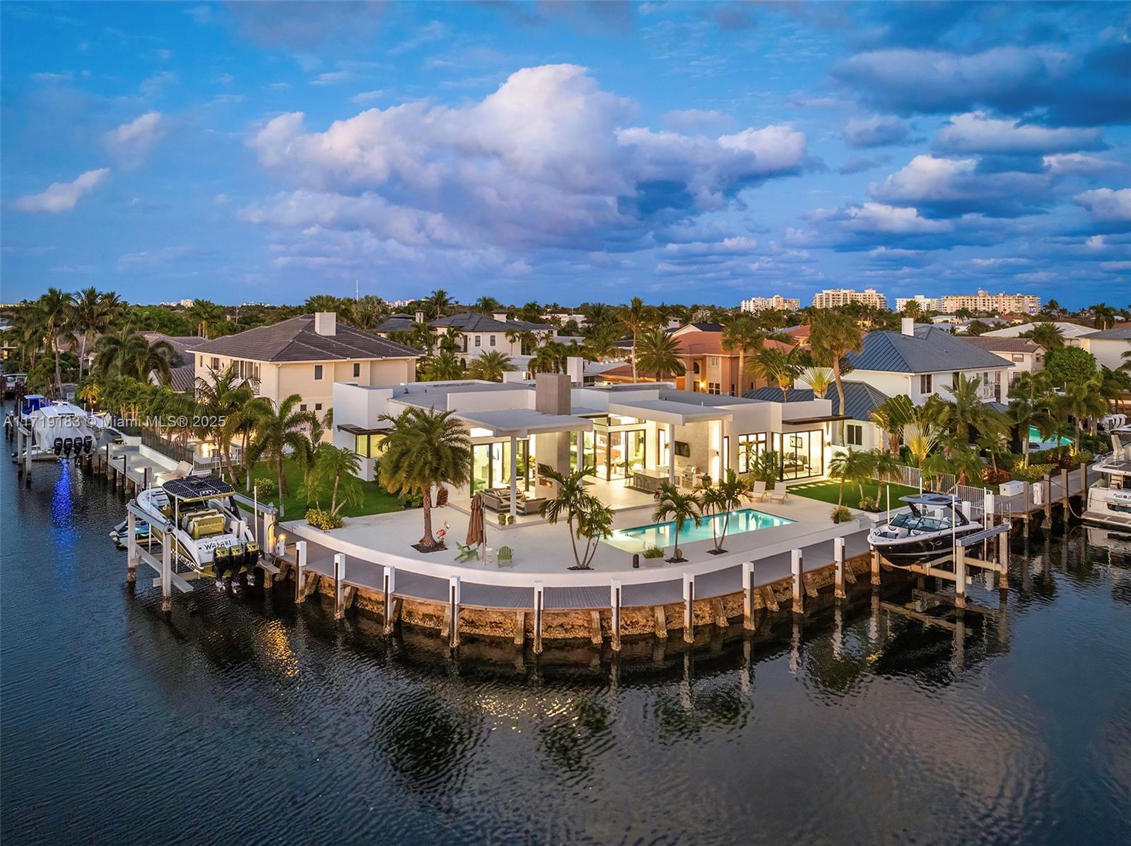 Experience the epitome of luxury in this brand-new modern ranch-style home built by renowned Zahn Builders, positioned perfectly on a coveted Southern point lot. Boasting over 200' of prime waterfrontage on the South Grand Canal, this gem is just minutes from the ocean. The home spans over 4,700 total square feet, including more than 3,000 square feet of outdoor space. Revel in the meticulous design with 3 primary-sized bedrooms, 4.5 lavish baths, a state-of-the-art gym, and an expansive 4-car garage. Outdoors, enjoy the convenience of two 25k LB lifts, perfect for your boating needs. The open-concept interior showcases no-expense-spared finishes, including mesmerizing backlit onyx countertops and select materials that exude opulence. A rare gem, this home defines sophisticated living.