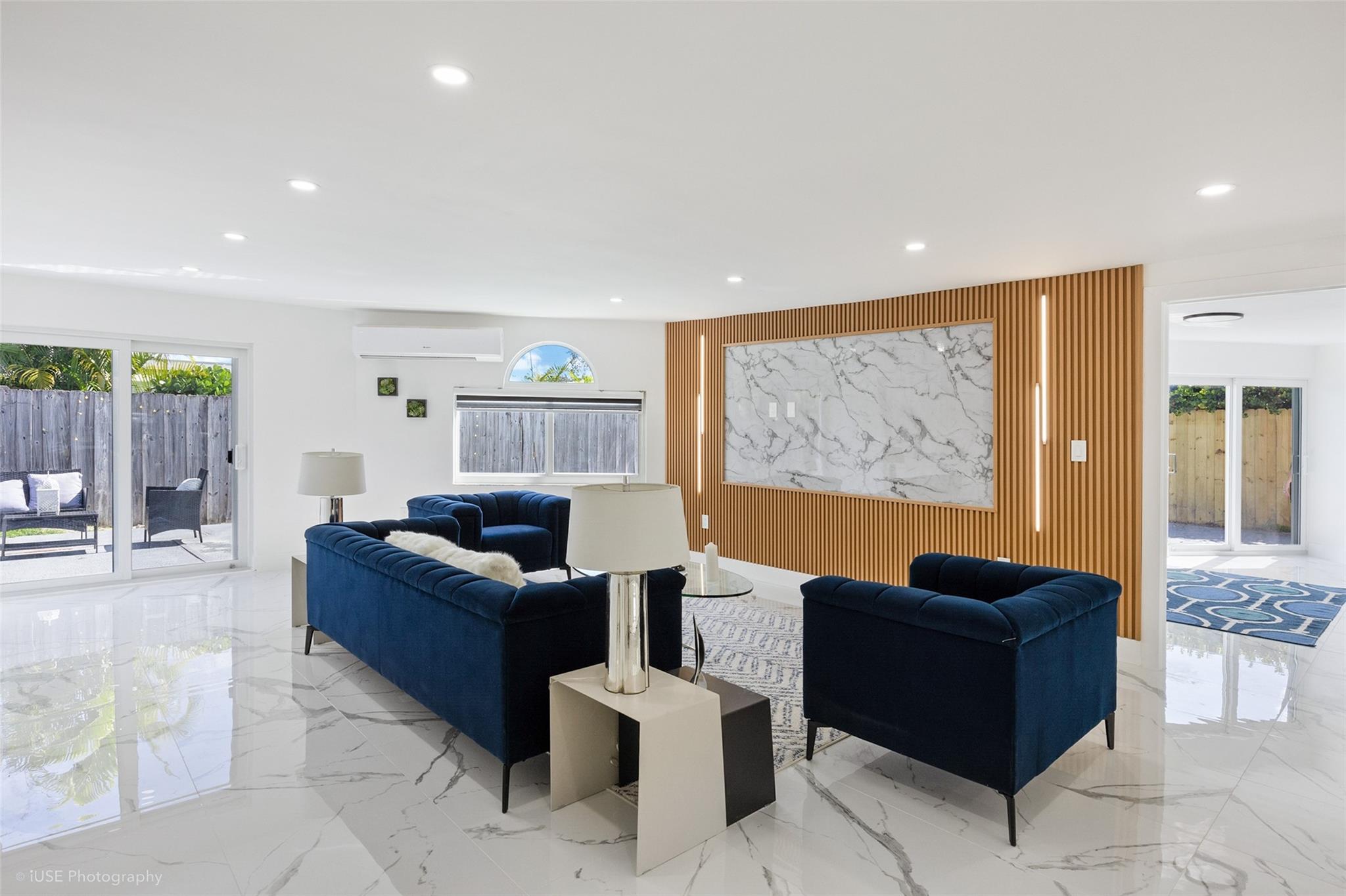 Living room with third bedroom off to the right. Pool and back yard to the left.