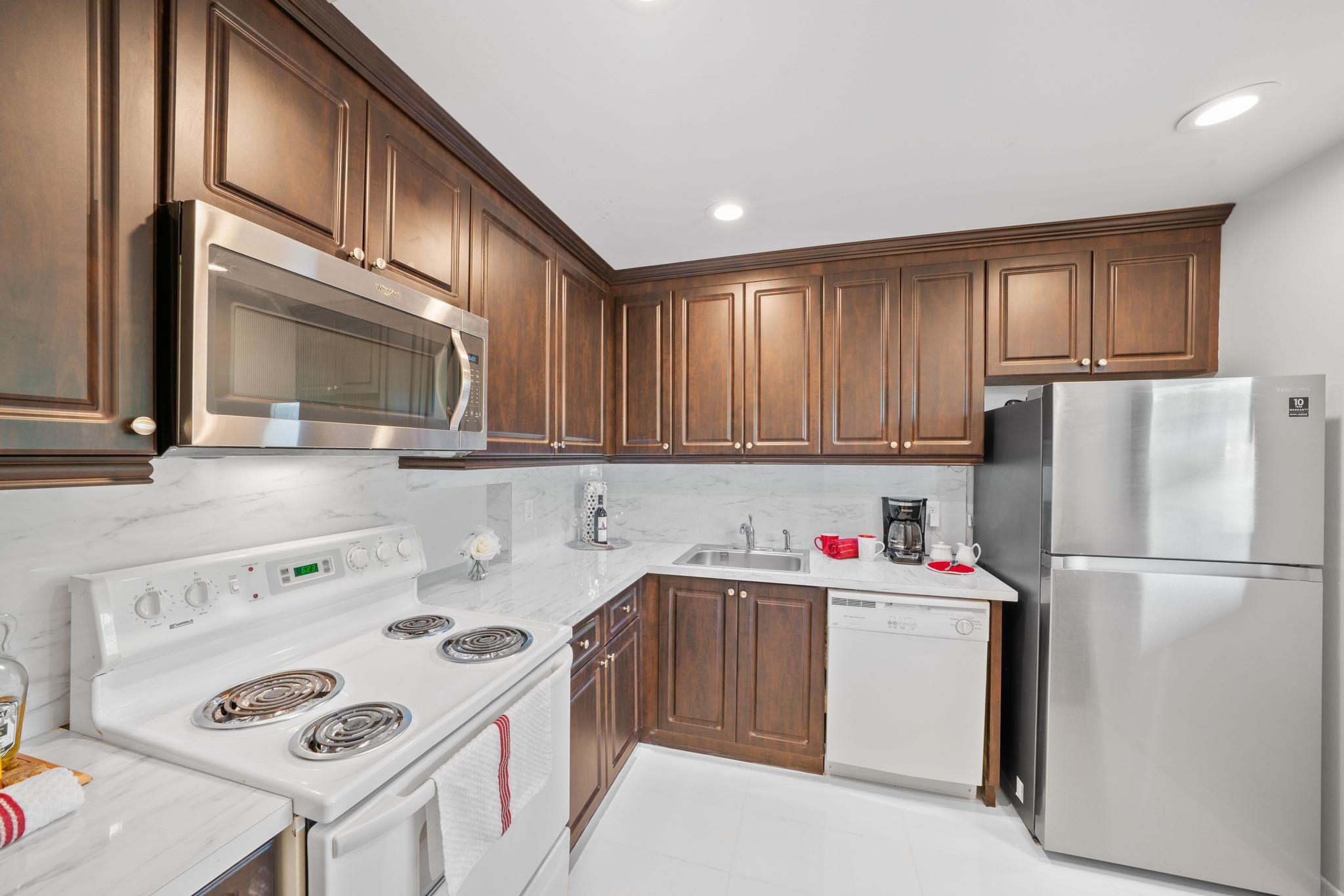 Bright, open kitchen with white backsplash and plenty of counter space.