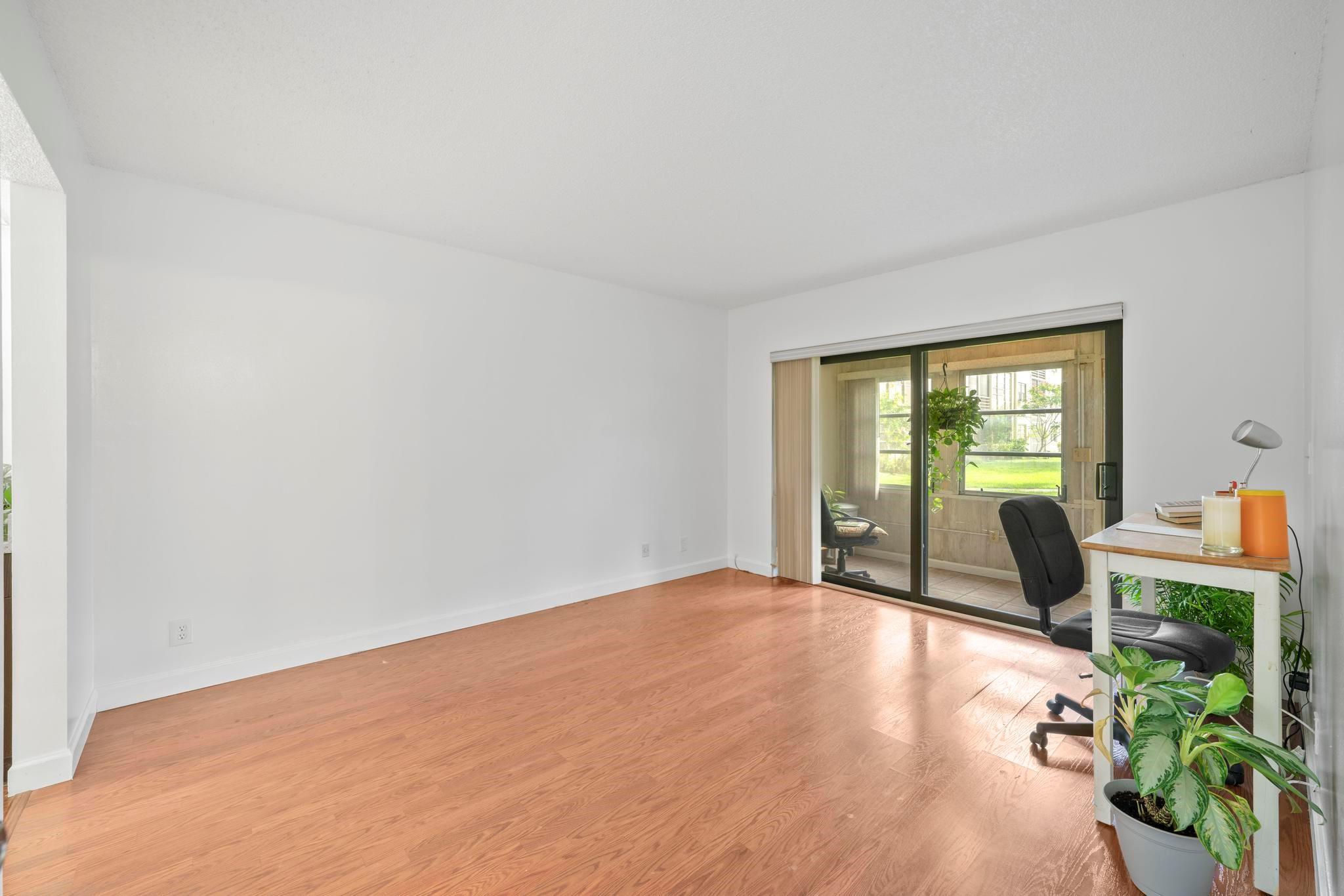 Primary features Impact Sliding Glass door that leads to private, screened-in patio.