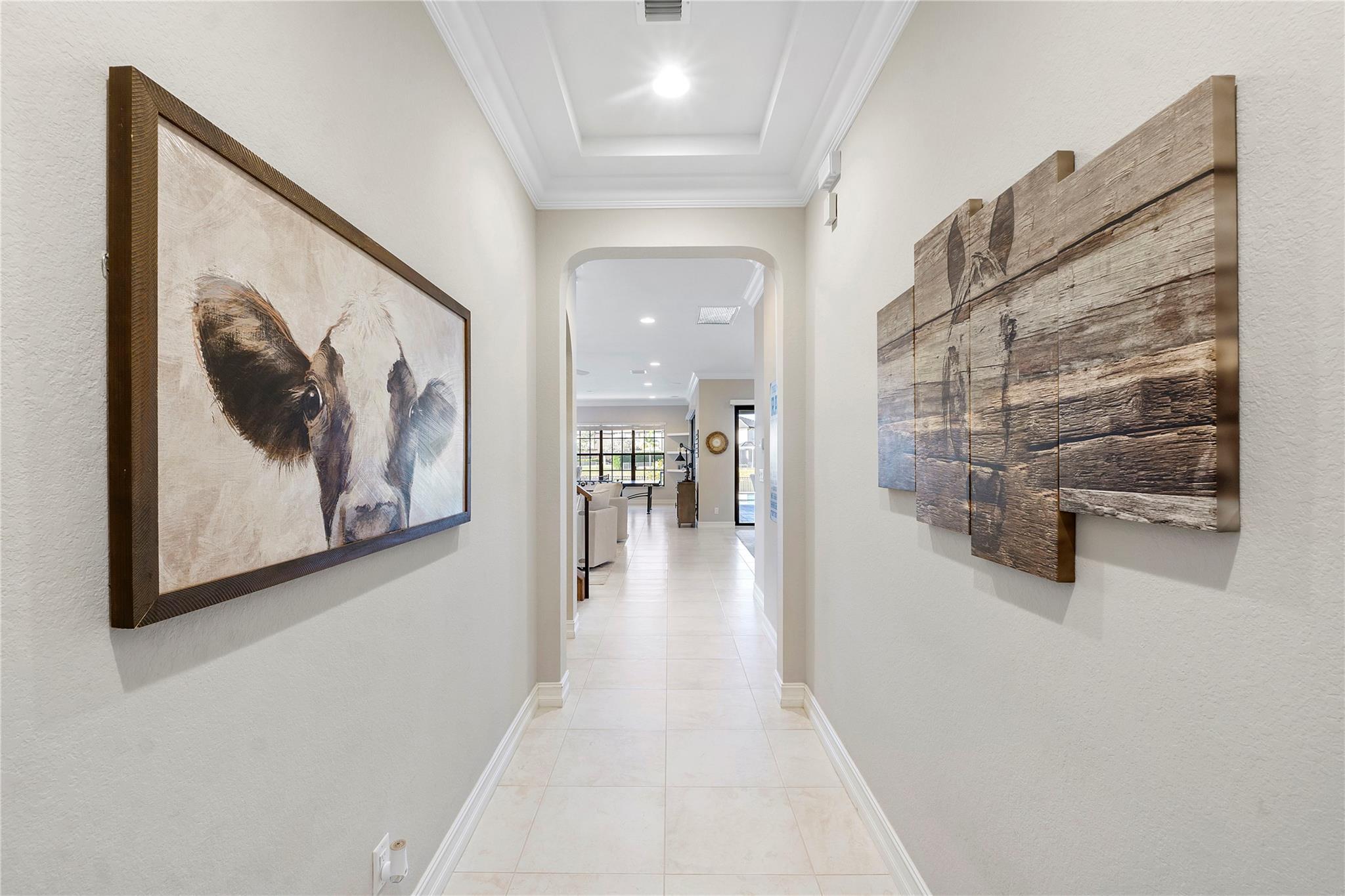 The entry hallway can be used as a Gallery as you walk into the home, 7 inch Crown moldings throughout this elegant residence