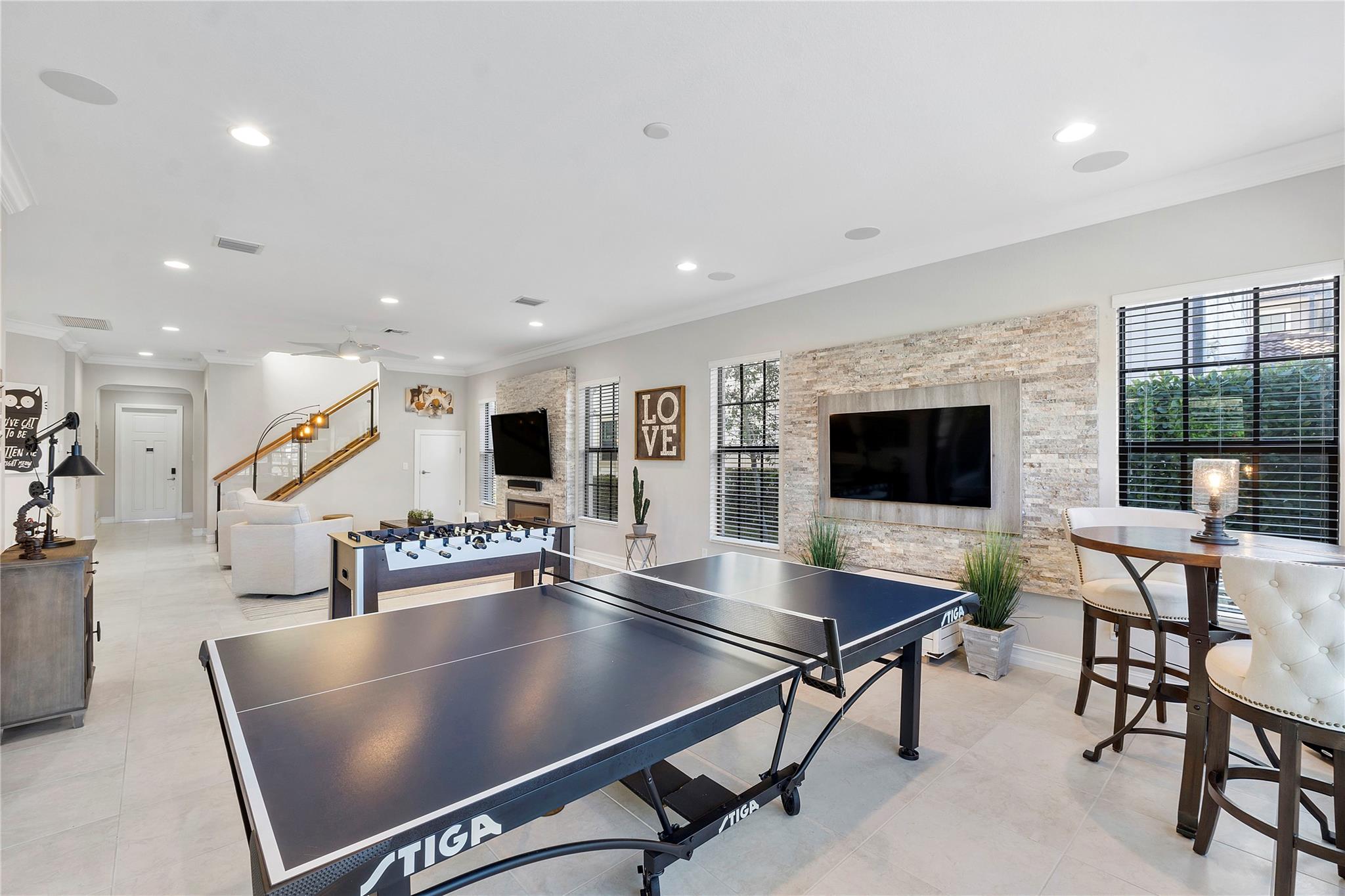 The living room and Family room combined makes a great open floorplan & has 2 real stone accent TV walls, Great for watching the game or your kids use one and you watch the other TV