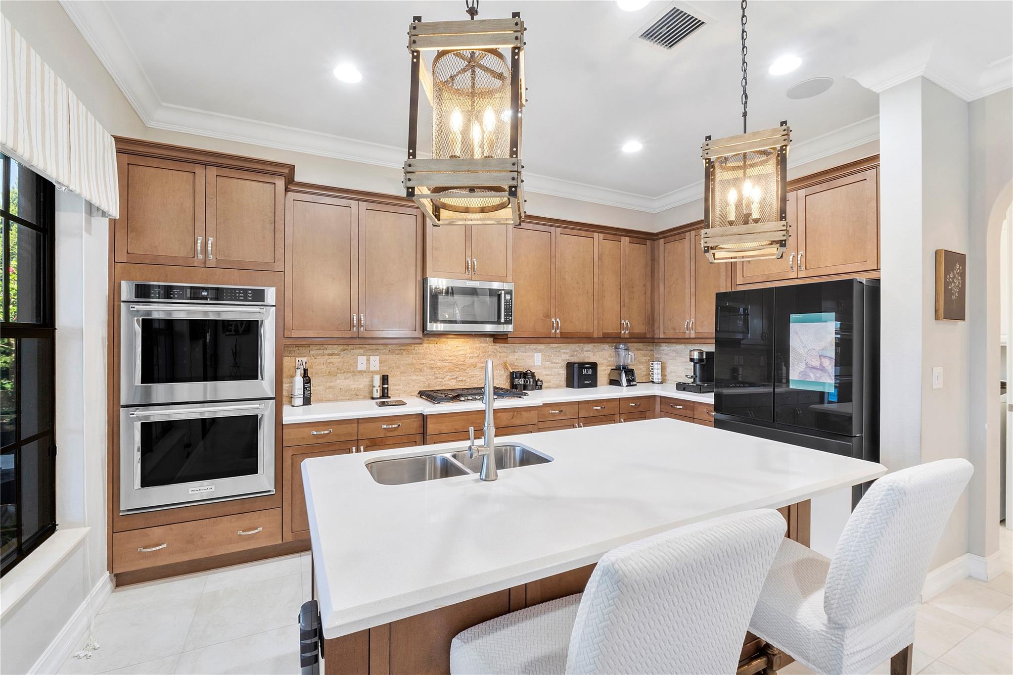 Look at those immaculate stainless appliances made by Kitchen Aide, Double Ovens so you can cook your Turkey and apple pie at the same time for Thanksgiving, Smart ALEXA voice stock up hub state of the art Samsung Refrigerator,