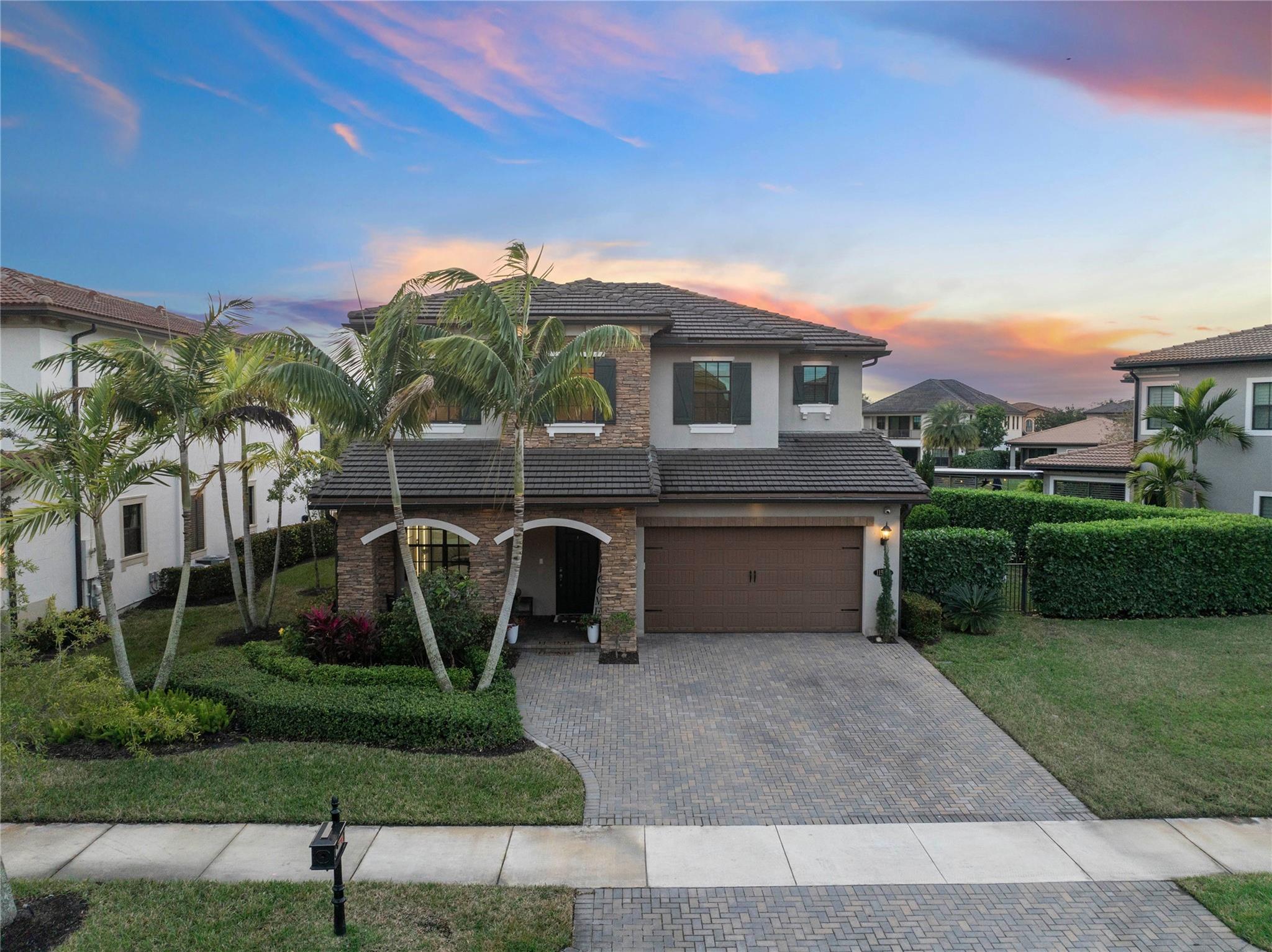 Sunset inside our Watercrest Community most nights this sunset leaves an orange & purple sky, sometimes a red sky, See the 2 story flat clay roof tile with impact windows and doors throughout, Impact garage doors also, Old English Stone elevation on the front of the house,