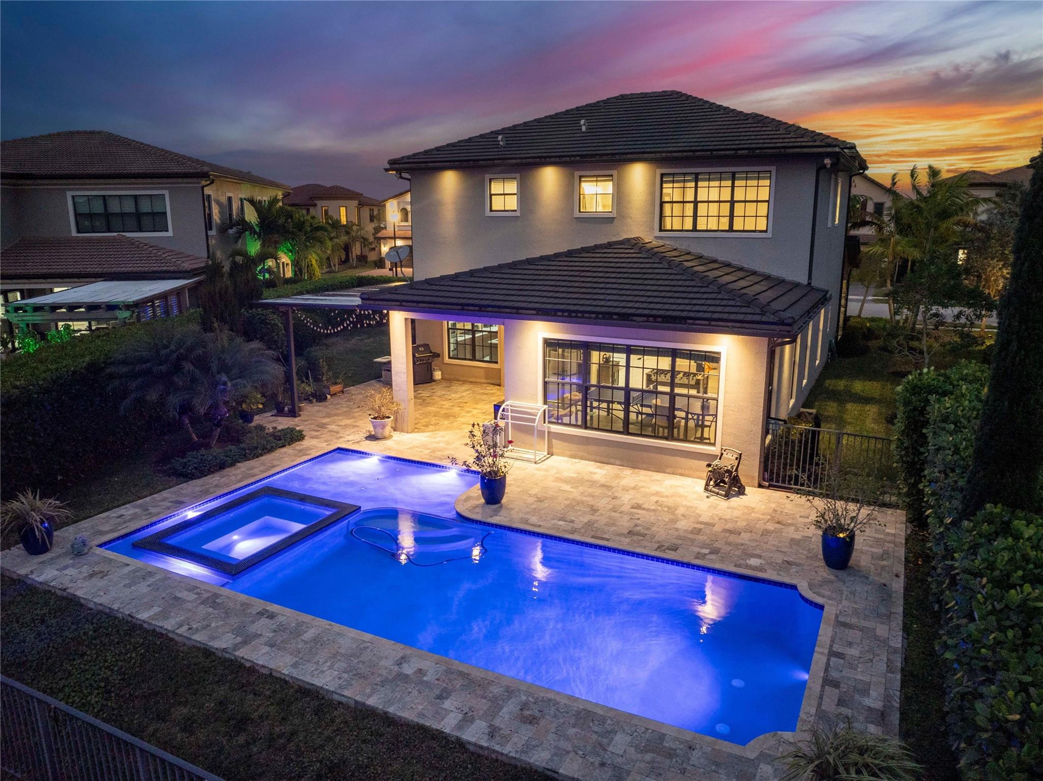 The back view of the house at night, all lit up,
The purple pool is the favorite color of the many L.E.D lights the pool can change in colo, or why not have it remotley set for 5 second intervals like a carousel.