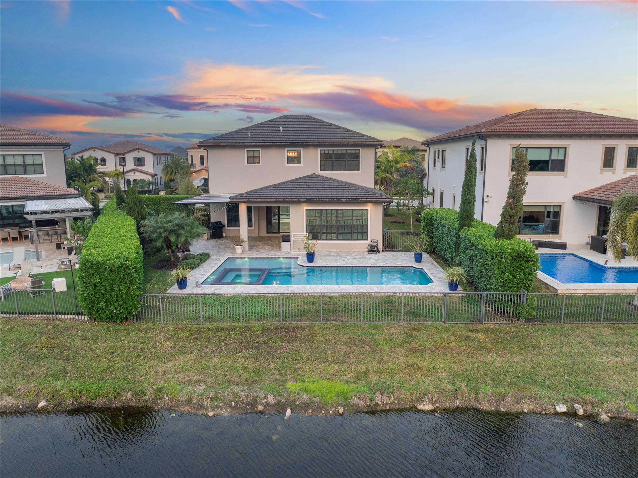 The back view of the home from a drone over the lake, sunset!