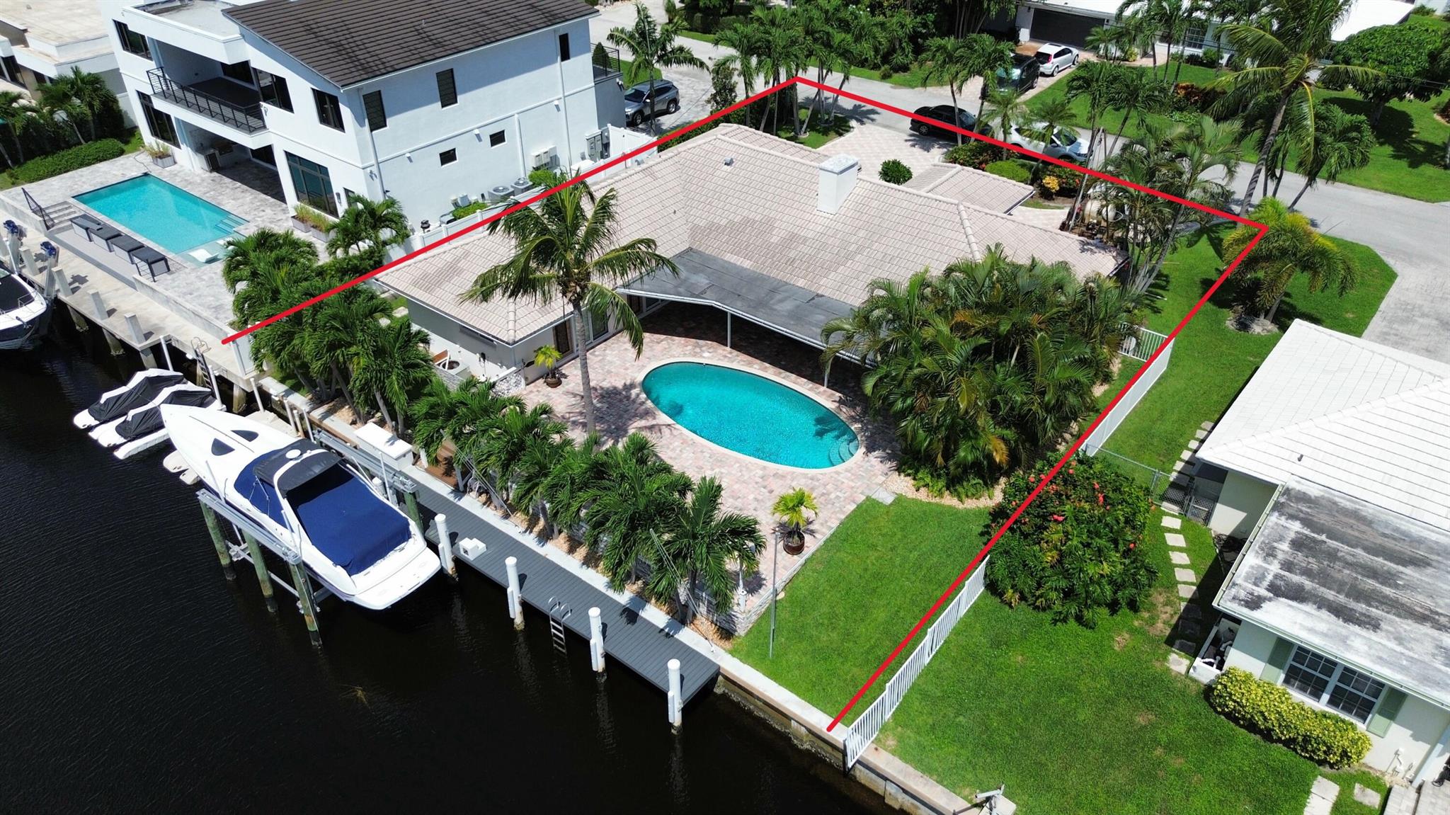 Southern-exposed deep-water home in the prestigious Bel-Marra community of East Boca Raton. A boater's dream with 85' of waterfront, a 50' dock with 220V power, a 16K boat lift, and two floating docks for kayaks and jet skis. NO FIXED bridges--just minutes by boat to Lake Boca, the inlet, and the open ocean. A paved circular driveway leads to a bright, open split-floor plan with a two-sided fireplace. Impact doors and windows throughout, new AC/HVAC, and a stainless kitchen with granite counters. The outdoor space features a spacious paved deck, pool, and built-in grill. Prime location near Mizner Park and Atlantic Ave's entertainment!
